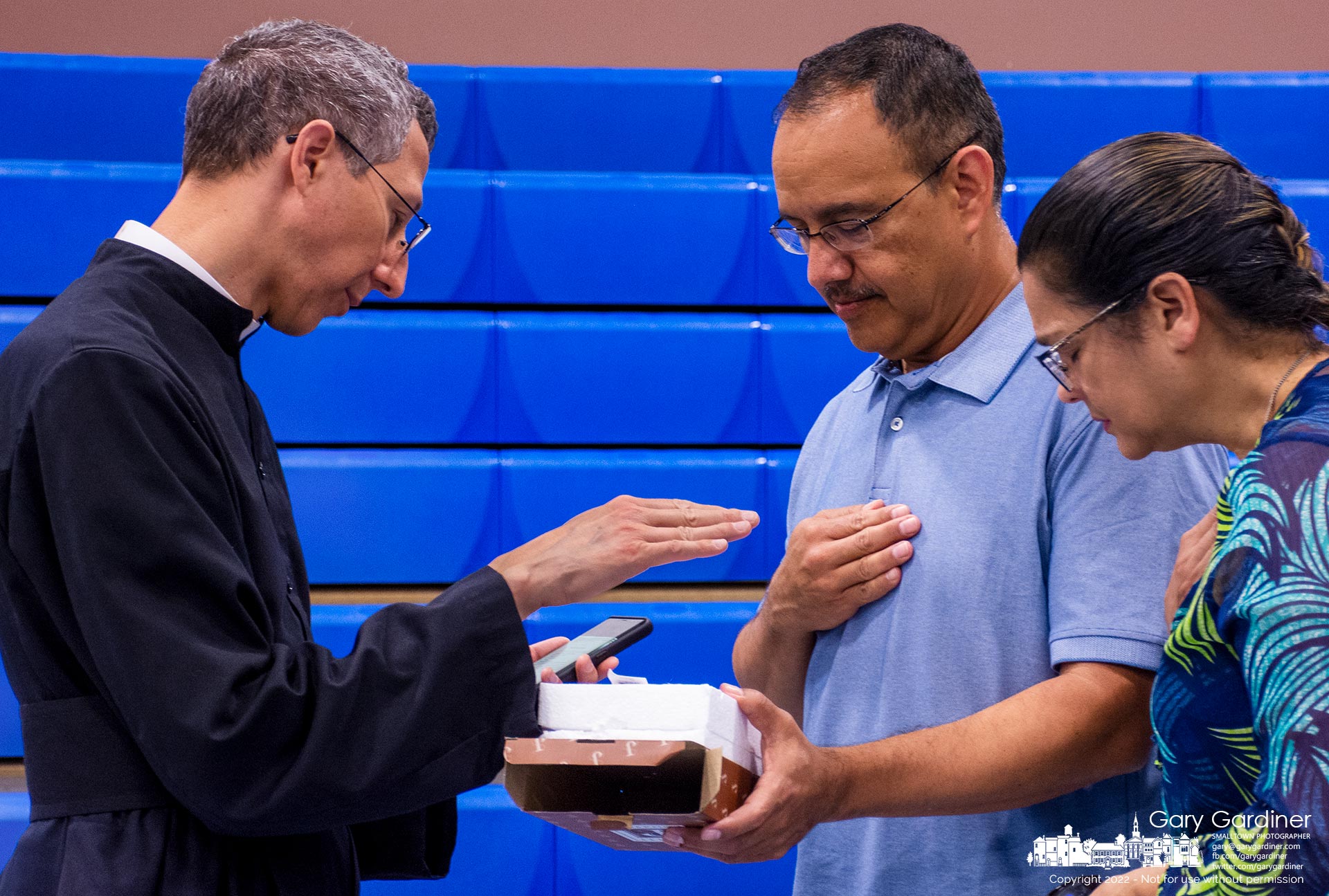 Fr. Daniel Olvera issues a blessing for a parishioner's new crucifix during a reception after the new parochial vicar for St. Paul gave his first Sunday Mass. My Final Photo for July 17, 2022.
