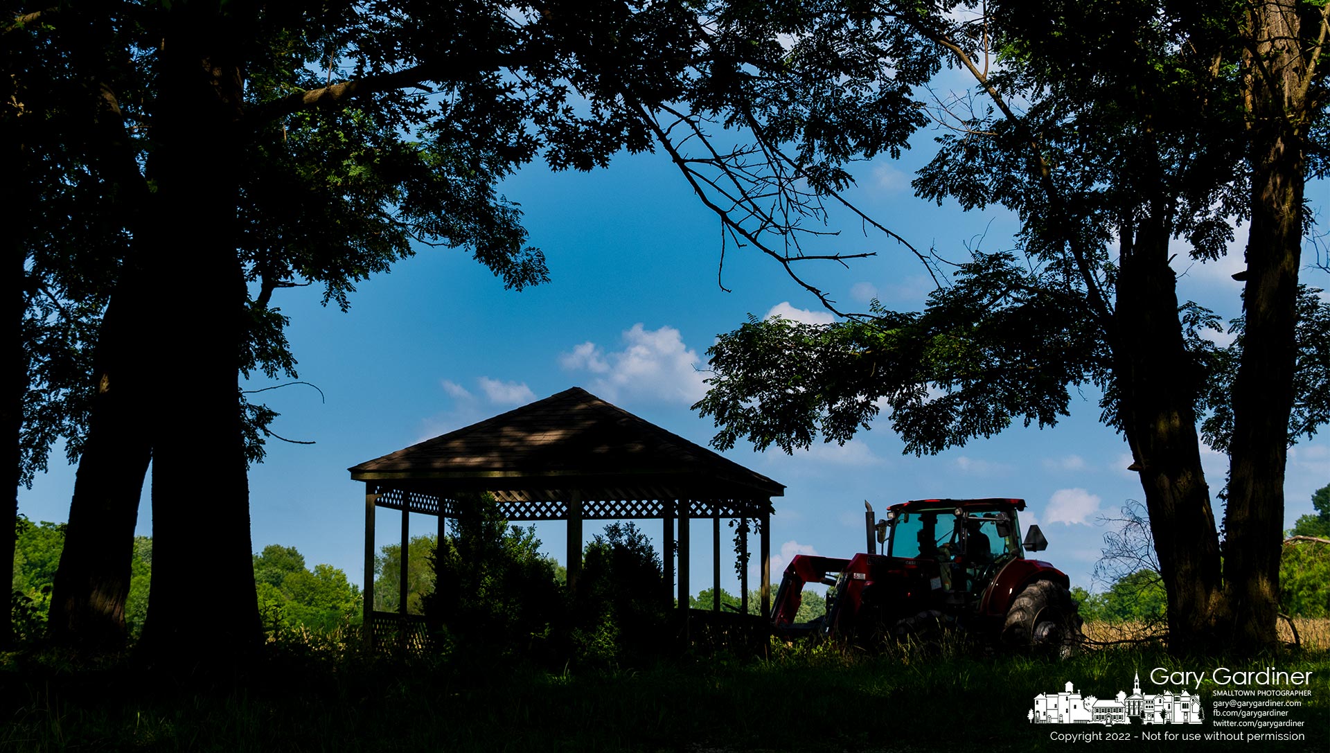 Kevin Scott runs his tractor pulling a hay mower through the afternoon shadows near the gazebo at the rear of the Sharp Farm home on Africa Road. My Final Photo for July 19, 2022.