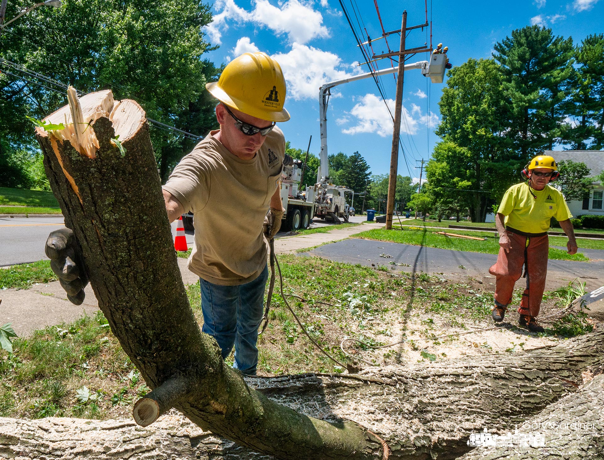 A Westerville electric work crew clears limbs and the trunk of a tree removed near a power line as a second crew replaces a utility pole that had seen its better days on East Walnut. My Final Photo for July 12, 2022.