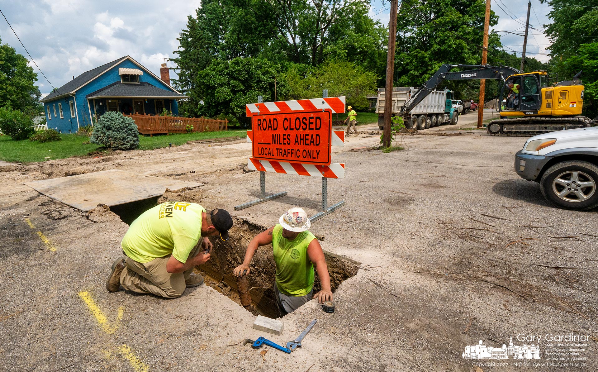 Two workmen attempt to repair a tubing cutter that failed while they were preparing to reconnect a house on East Home Street after laying a new water main before the roadway gets rebuilt. My Final Photo for August 11, 2022.
