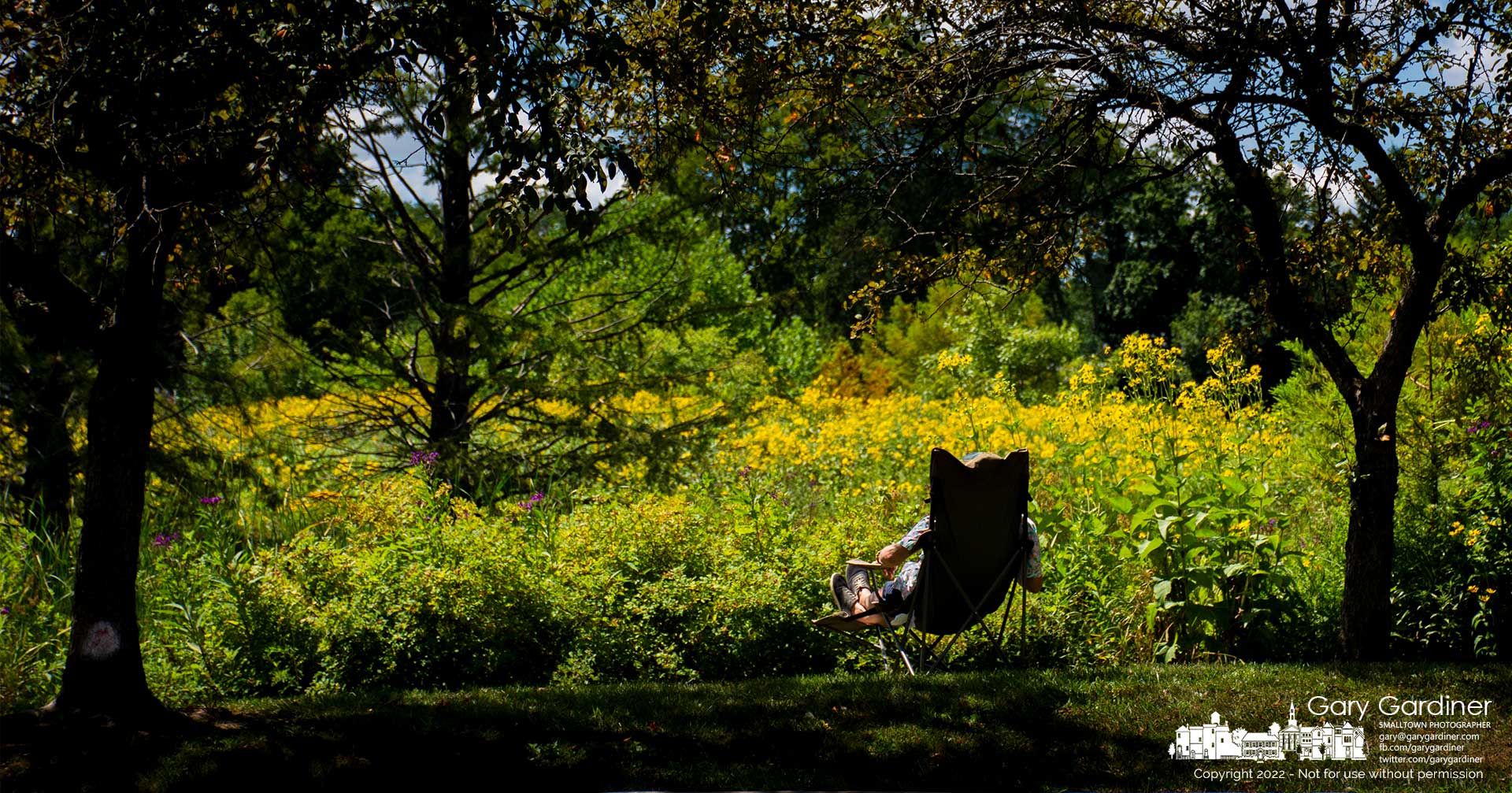 A man sits in a portable chair beside the wetlands at Highlands Park where he relaxes for s few moments during recovery from a medical problem. My Final Photo for August 12, 2022.