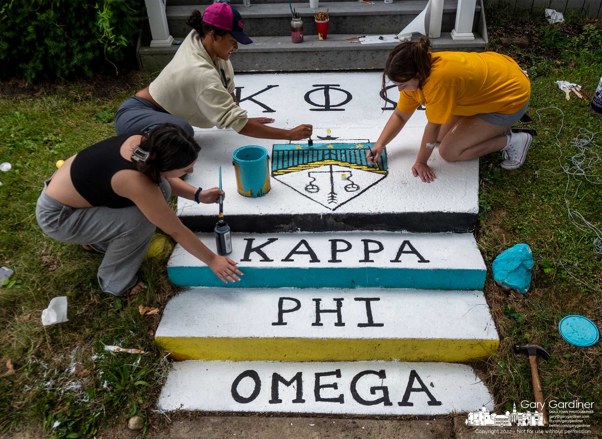 Otterbein University Kappa Phi Omega sorority sisters paint steps leading to the house on West Main Street as they prepare for the opening of school in a week and rushing new pledges. My Final Photo for August 14, 2022.