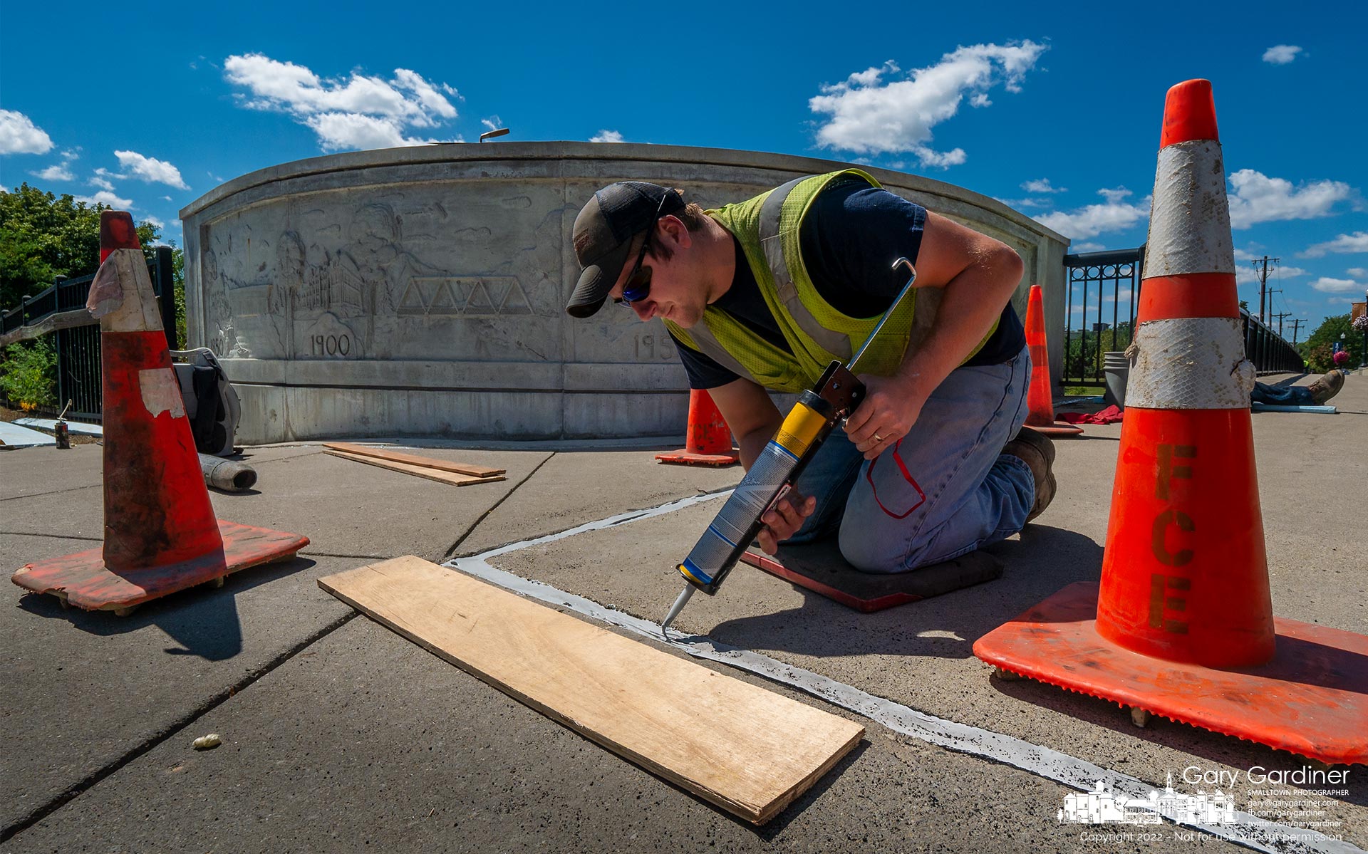 A Franklin County Engineer worker spreads self-leveling caulk into expansion points at the Main Street bridge resealing the expansion joints. My Final Photo for August 31, 2022.