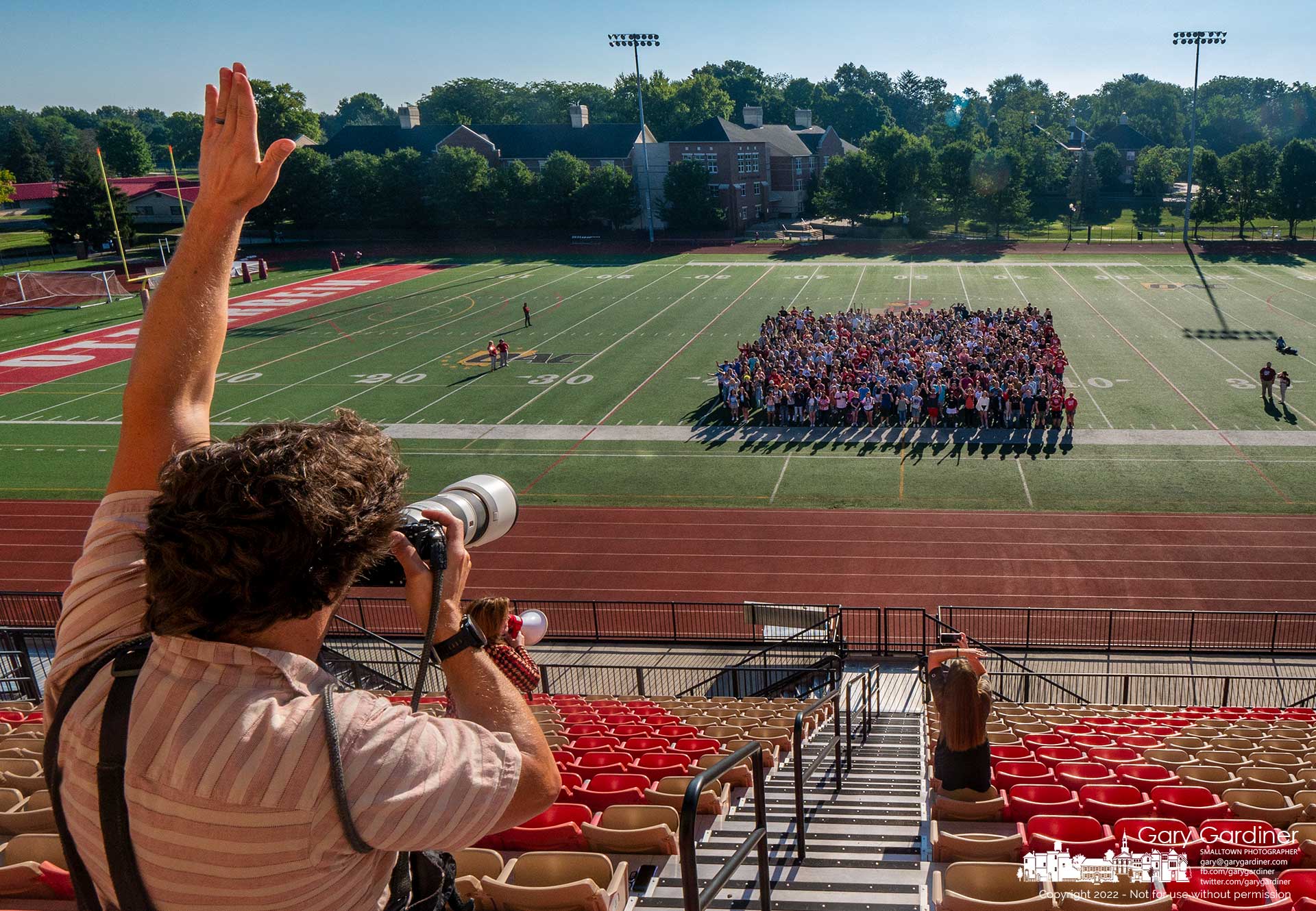 Photographer Jeffry Konzal signals the Otterbein University freshman class posing for the first class photo taken at the university's football stadium. This week is freshman orientation week with classes starting Monday. My Final Photo for August 18, 2022.