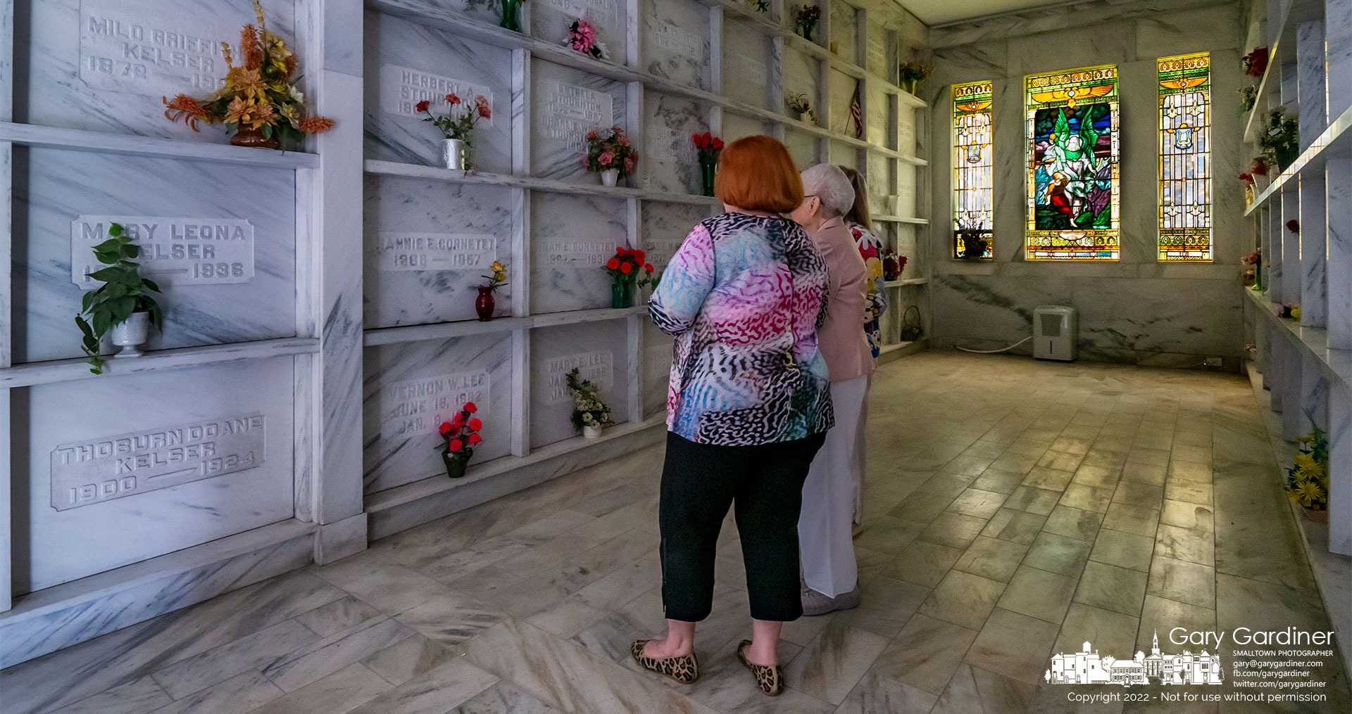A mother and her two daughters stand in a section of the Otterbein Cemetery Mausoleum in front of a family member's crypt during the Ohio History Connection Open Doors statewide tour of historical buildings and landmarks. My Final Photo for Sept. 13, 2022.