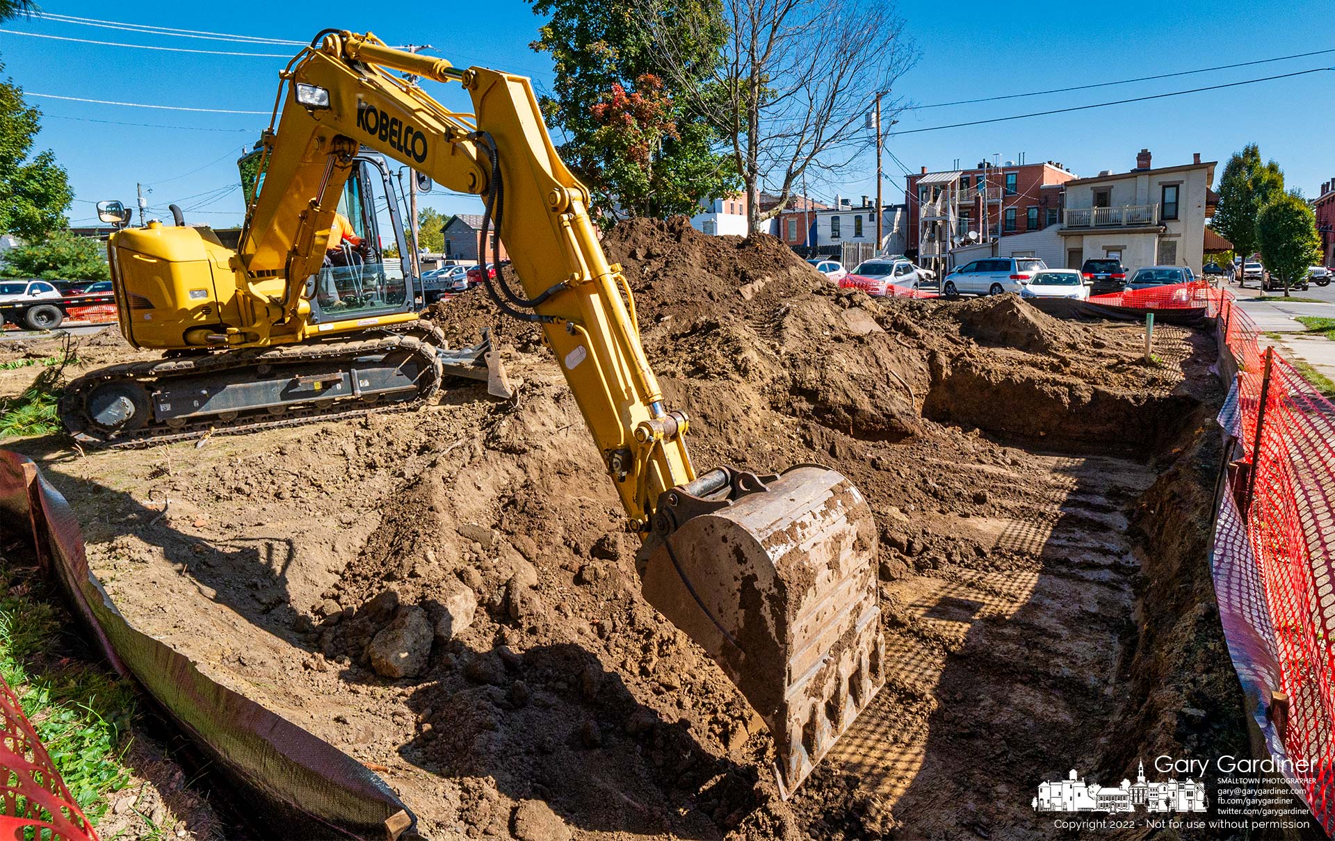 A contractor uses a backhoe to clear dirt from beneath where the Book Harbor bookstore stood to prepare for a new foundation as the property is converted to a multiple-story business and office building. My Final Photo for October 3, 2022.