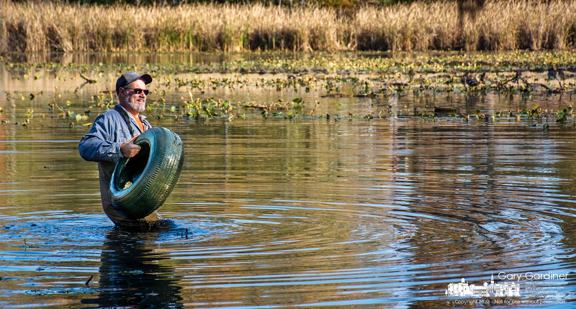 Mark Dilley removes a tire from the pond at Boyer Nature Preserve during Saturday's removal of invasive species, including tires, from the park, My Final Photo for October 22, 2022.