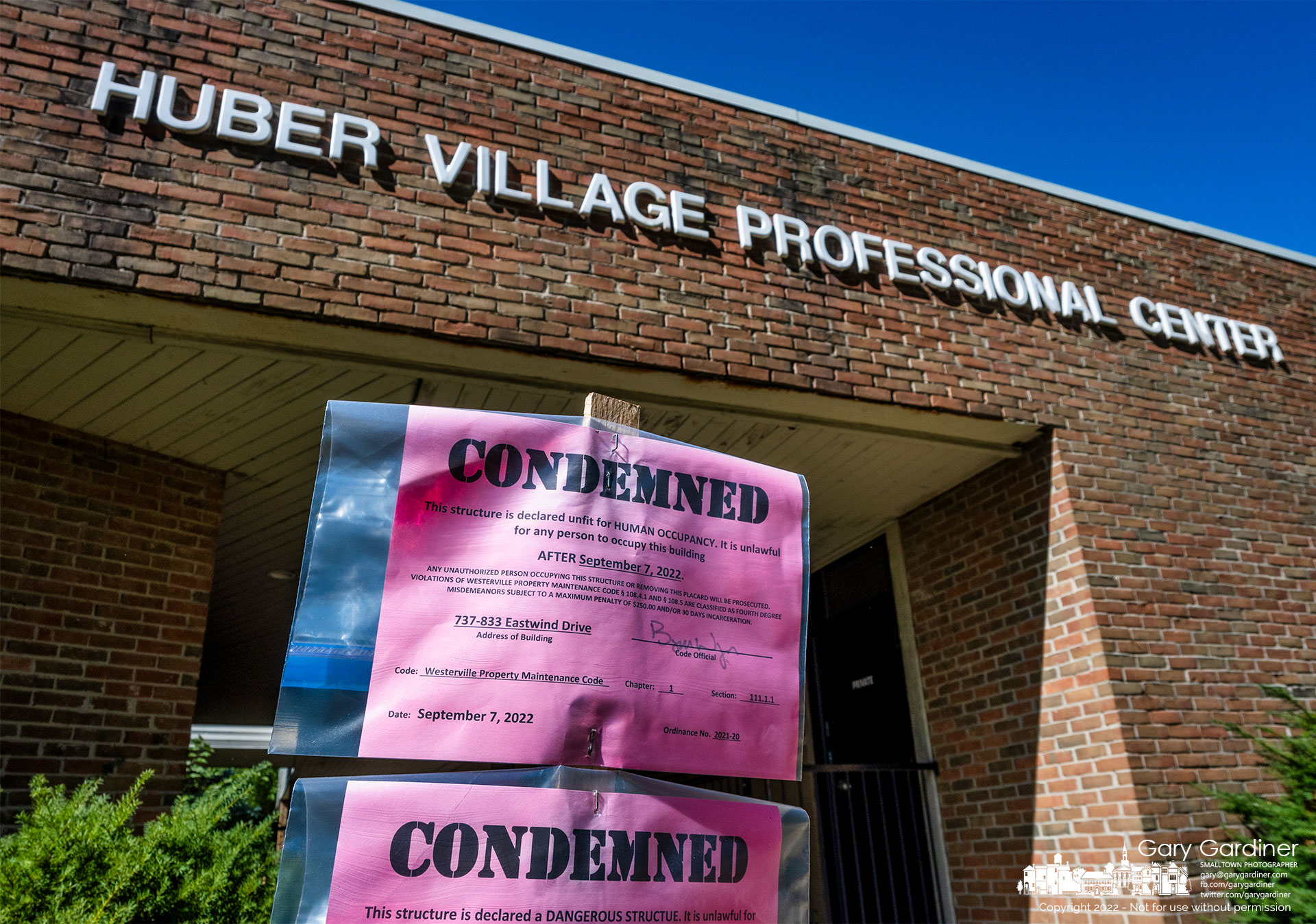 Condemned notices mark the condition of the former medical office at Huber Village Blvd. and Eastwind Drive where a planned drug treatment facility began demolishing the old offices before stopping construction. My Final Photo for October 5, 2022.