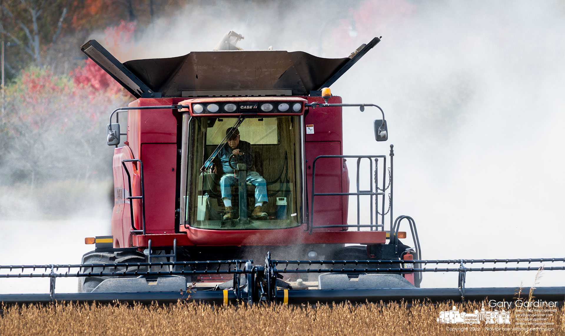 A cloud of dust created when harvesting soybeans trails a combine moving through the lower field at the Yarnell Farm. My Final Photo for October 16, 2022.