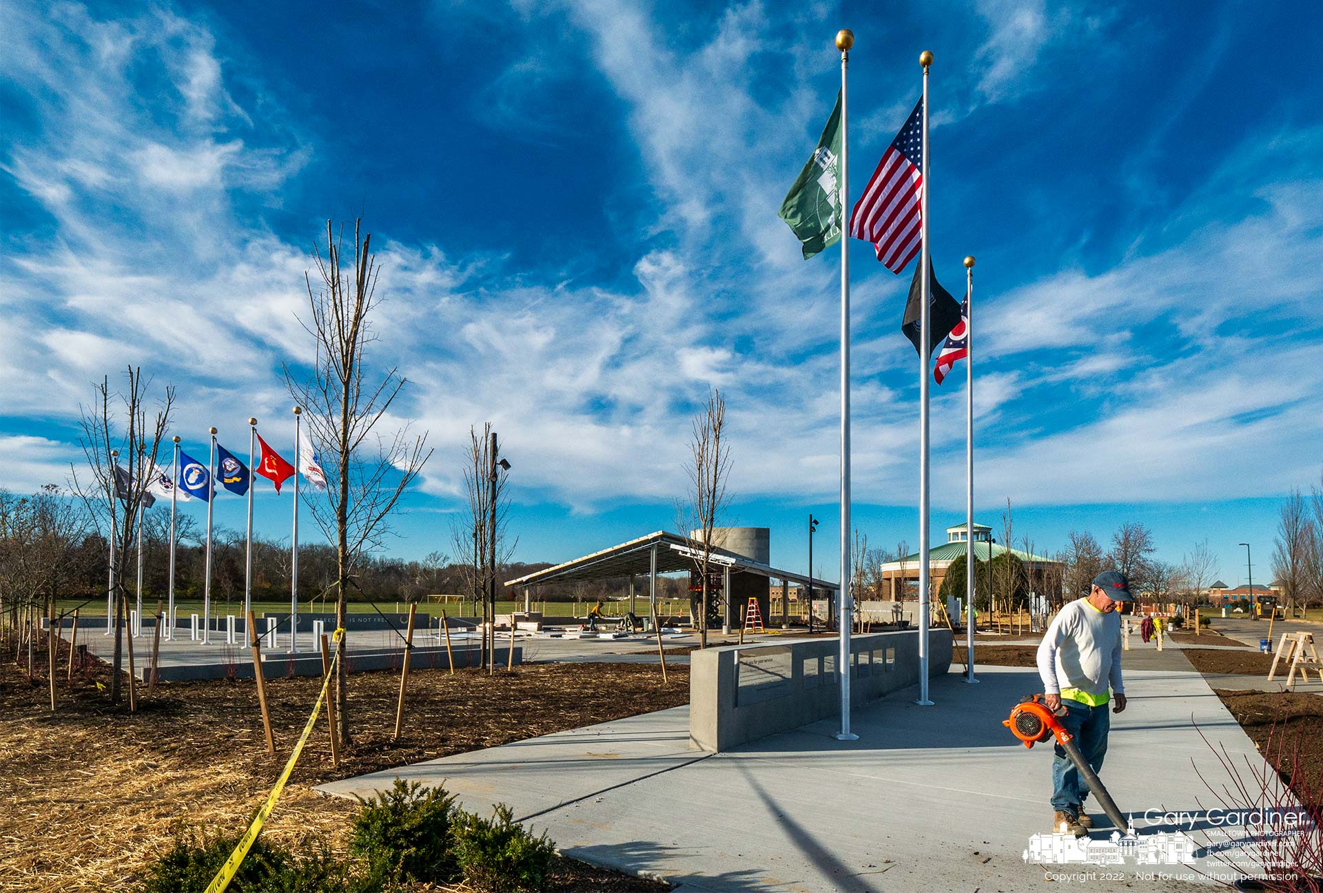 Newly raised flags blow in the breeze as workers ready the partially completed Veterans Memorial for its de3dication on Friday. My Final Photo for November 9, 2022.