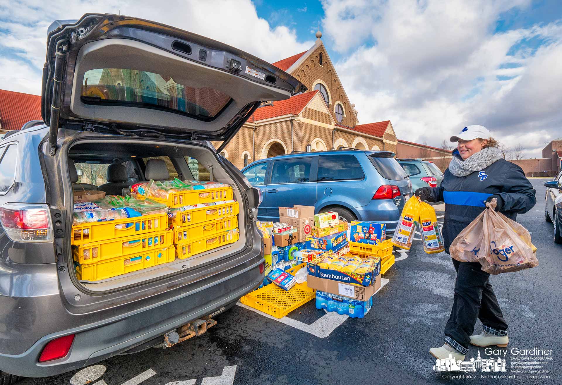Volunteers load donated sandwiches and snacks into cars at St. Paul the Apostle Catholic Church where they will be delivered to food kitchens at St. Lawrence Haven and Holy Rosary/St. John for use during the Christmas season. My Final Photo for November 30, 2022.