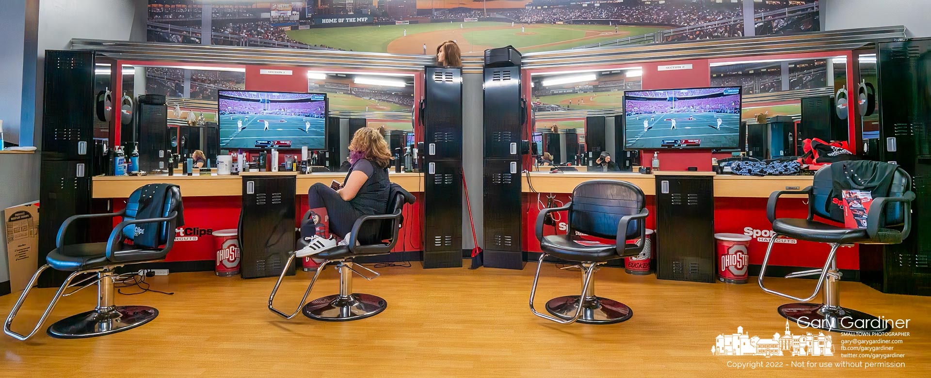 A beautician sits in her work chair watching the Ohio State-Michigan football game as one of the people in Westerville who could only watch the game while they worked. My Final Photo for November 26, 2022.