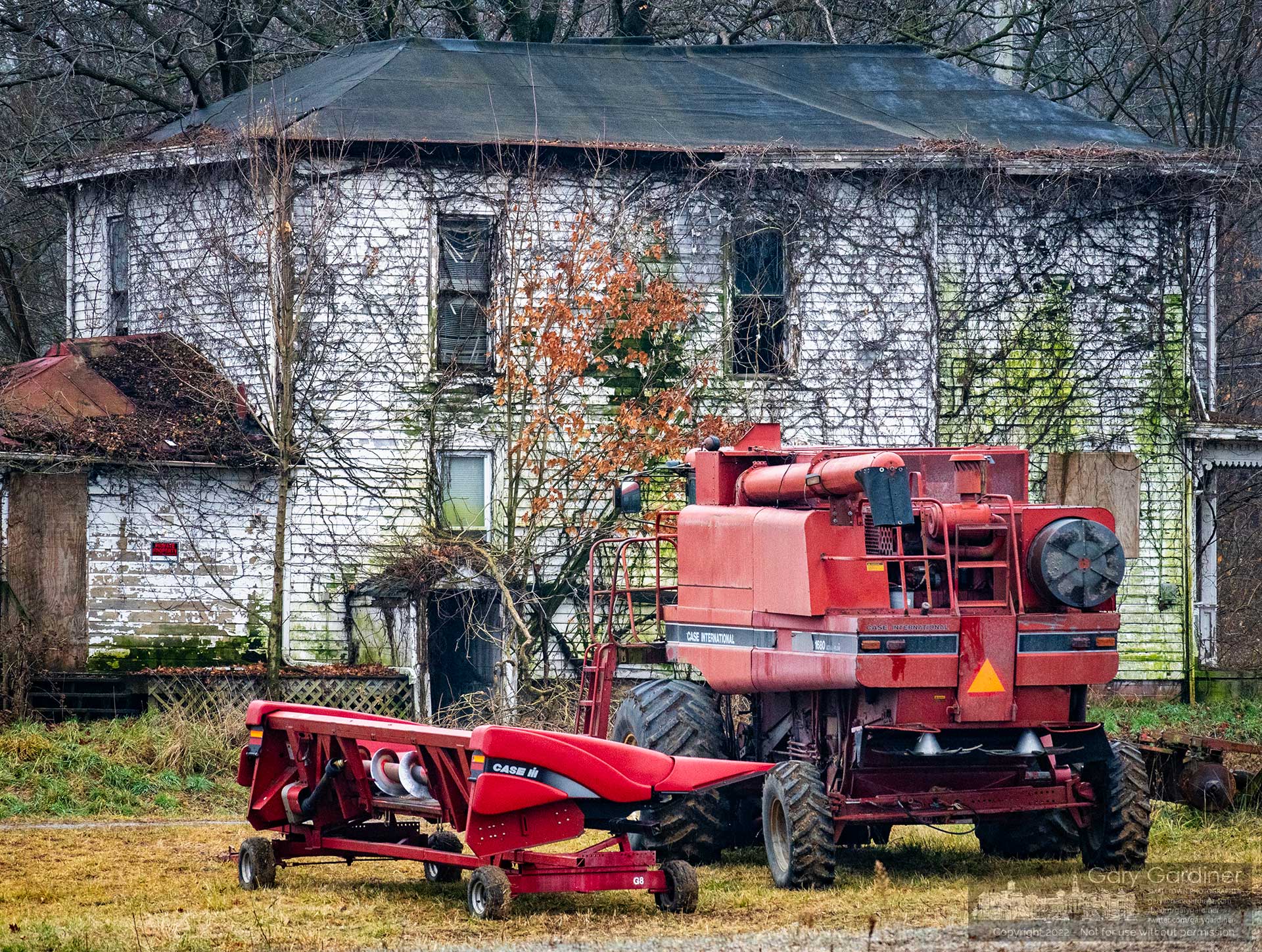 A combine with its corn harvester head removed at the completion of the season's harvest sits on the open ground beside the old farmhouse at the Braun Farm where the owners plan to demolish the house and barn to make way for a mixed-use development on the land along Cleveland Ave. and Cooper Road. My Final Photofor December 7, 2022. 