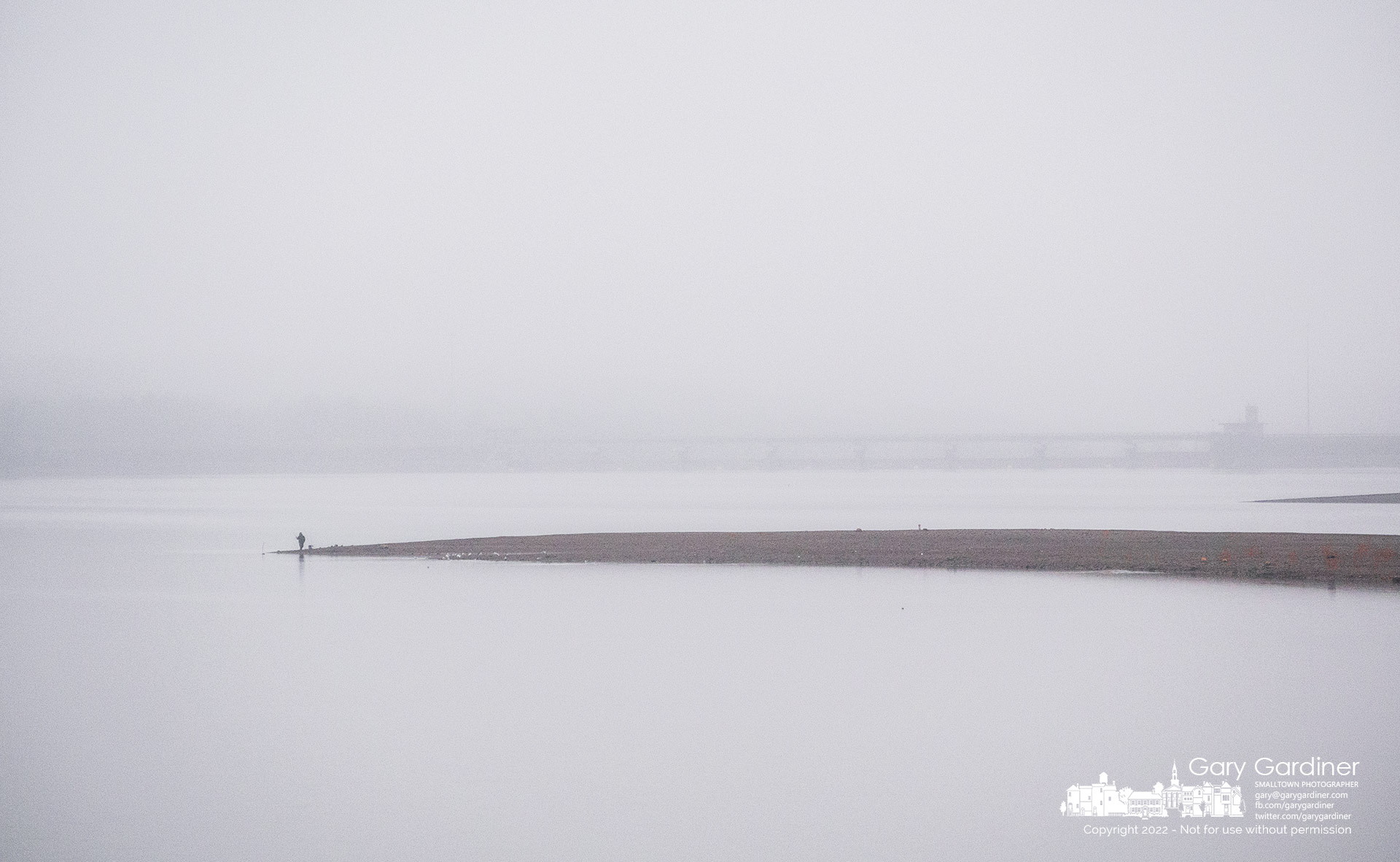 A fisherman stands in afternoon fog and mist at a distance from the dam at Hoover Reservoir hoping for luck after walking to the edge of the lake on a spit of land exposed by low water. My Final Photo For December 6, 2022. 