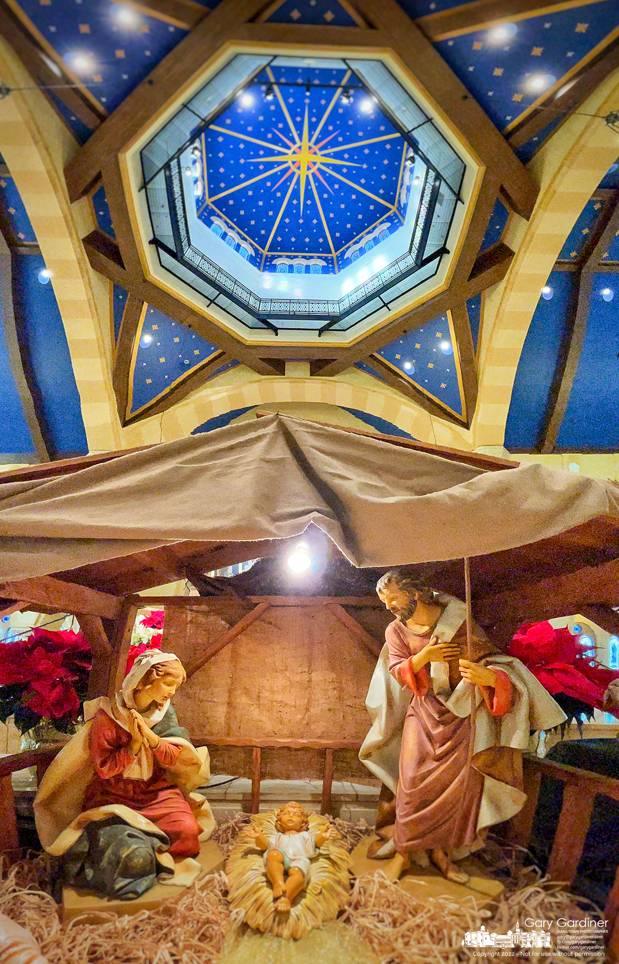 The Nativity scene sits at the front of the altar and beneath the domed ceiling at St. Paul the Apostle Catholic Church bearing a star symbol marking the birth of Christ. My Final Photo for December 25, 2022.