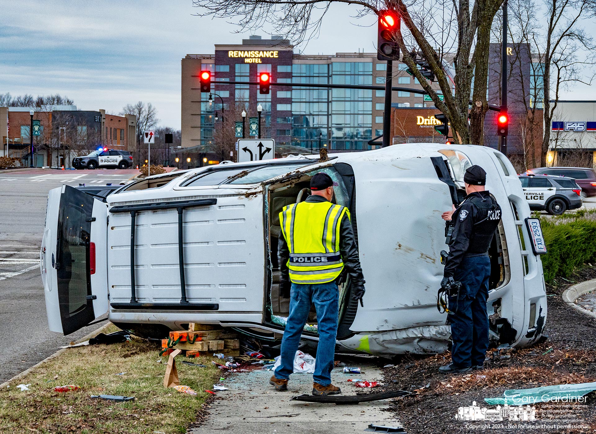 Westerville police crash investigators talk as they inspect a single-car crash at Polaris Parkway and Meridian Way late Sunday afternoon that required a person to be transported to the hospital. My Final Photo for January 8, 2023.