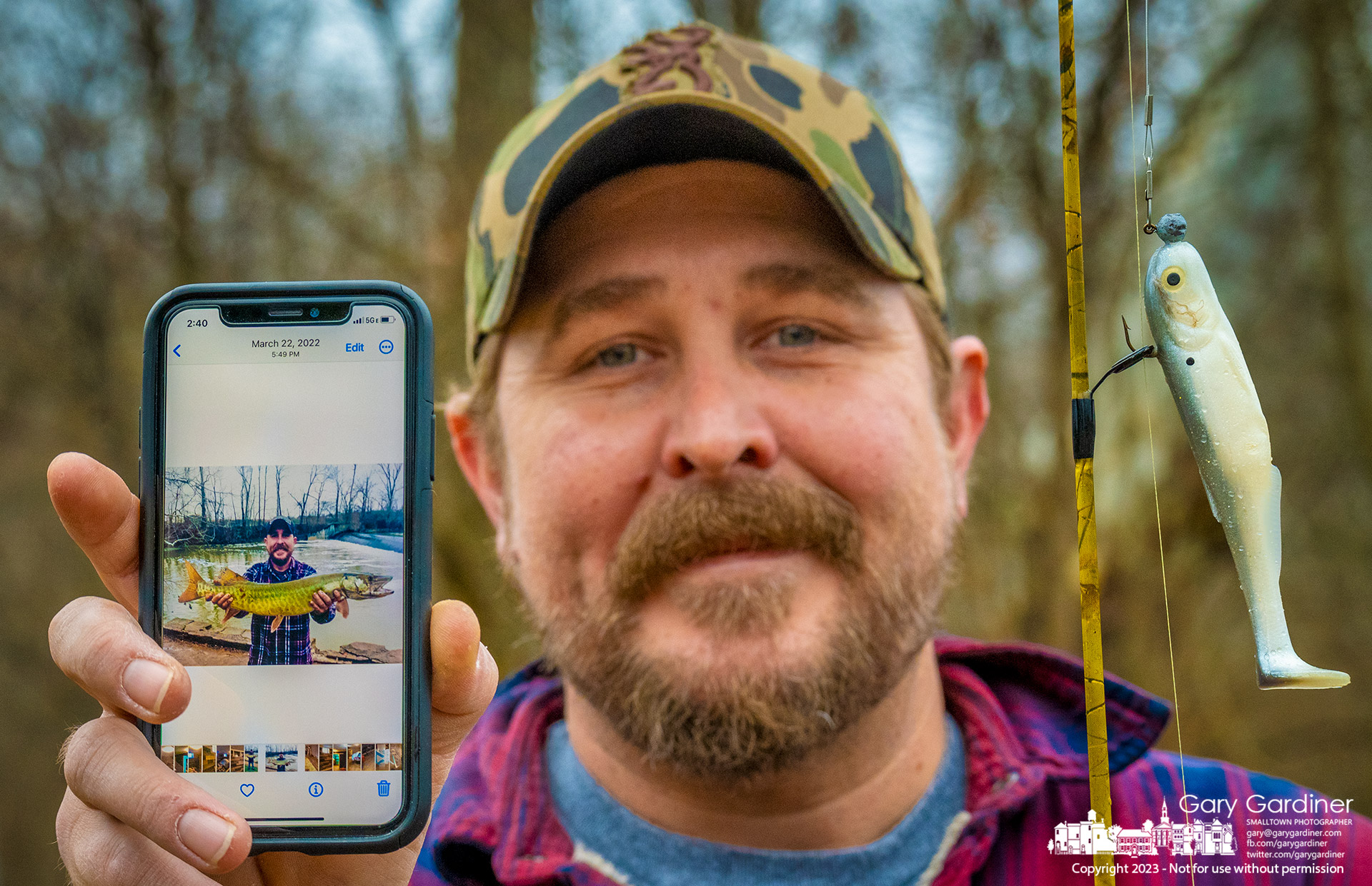 A fisherman proves his success fishing for Muskie below the Alum Creek Park North low-head dam by showing a catch preserved in a photo on his smartphone as he leaves the creek after failing to catch anything Monday. My Final Photo for January 2, 2023.