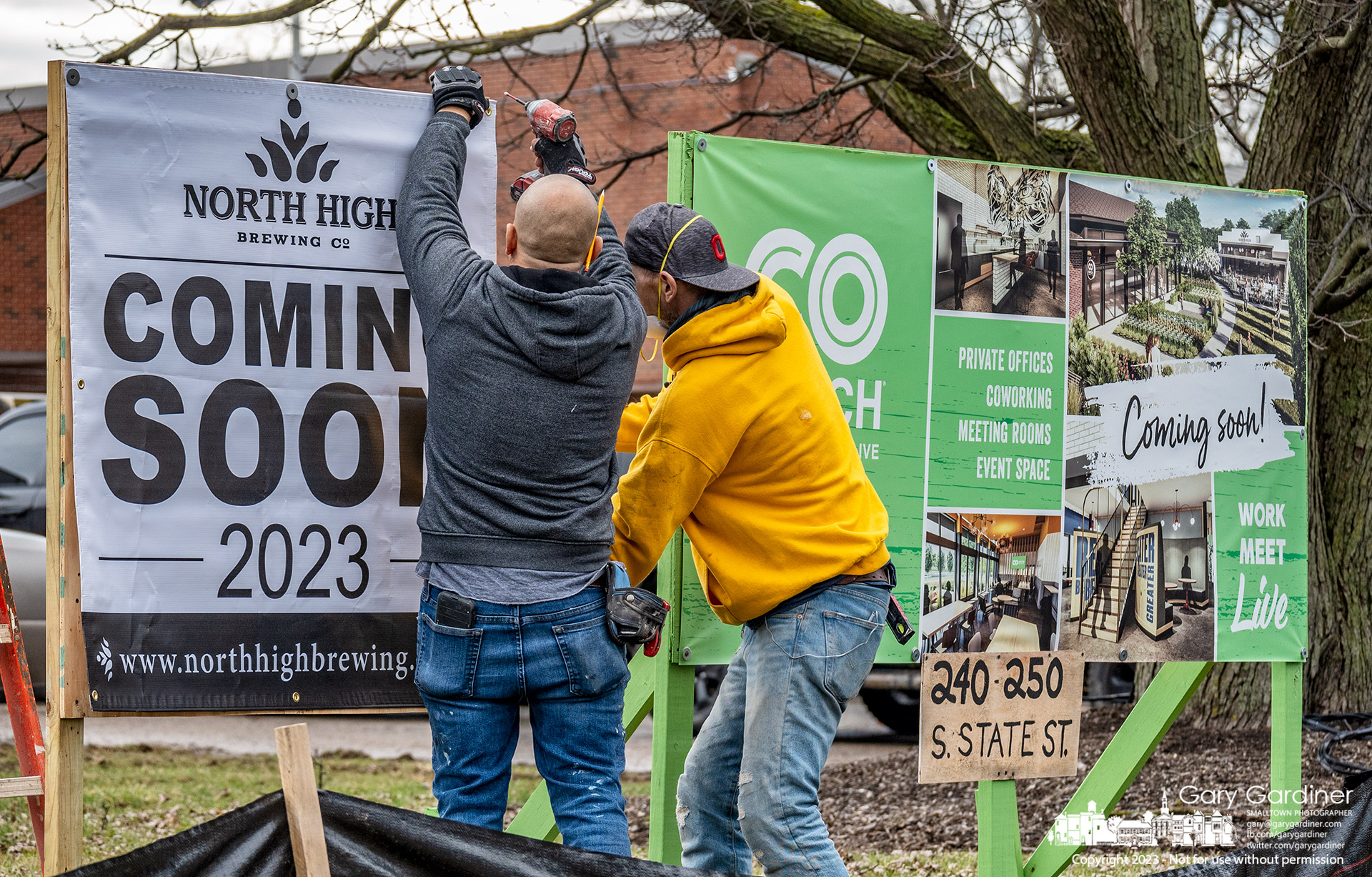 Workers install a sign proclaiming the coming of North High Brewery to a space behind coHatch in the old Westerville Armory on south State Street next to the post office. My Final Photo for February 9, 2023.