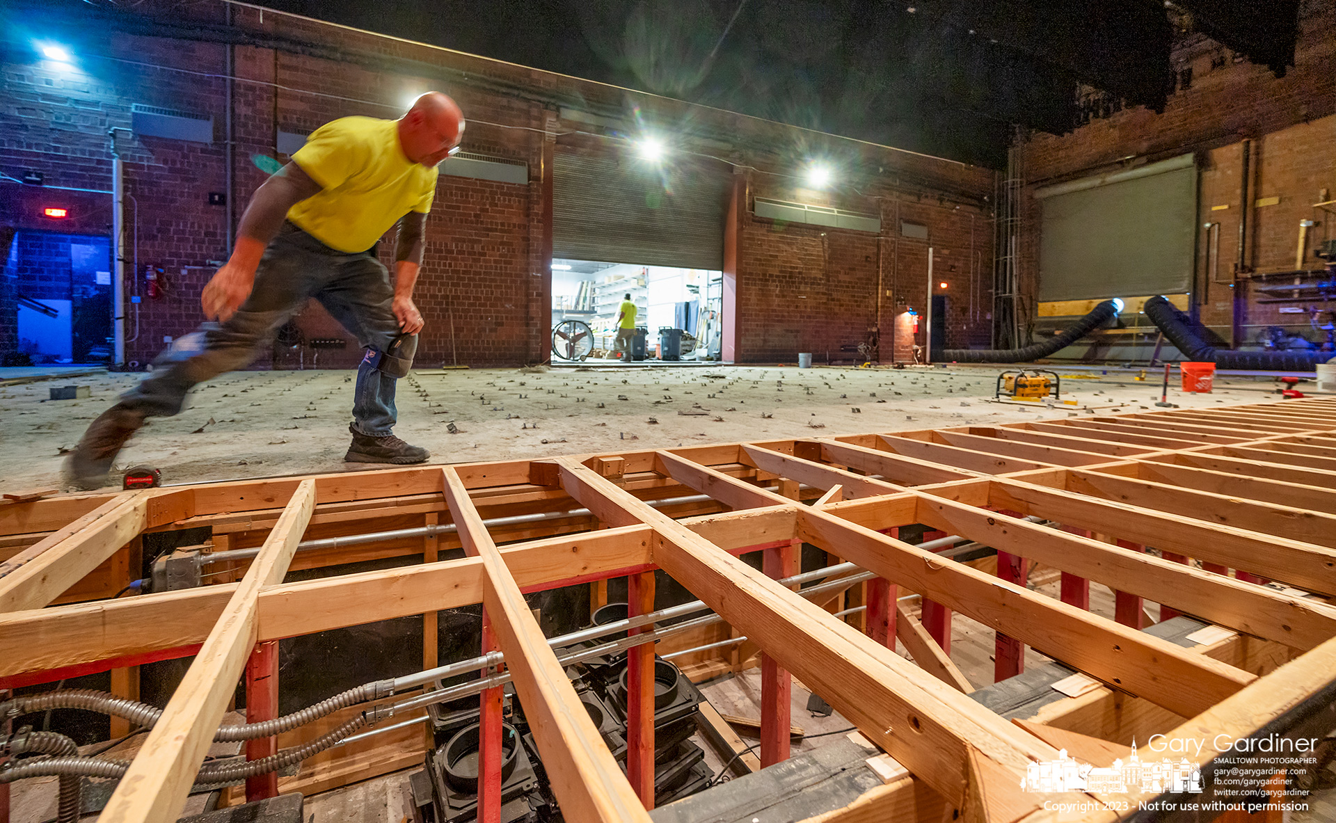 A carpenter strides across the stage in Cowan Hall at Otterbein University measuring sections before beginning to replace the entire floor after a broken water pipe flooded the stage several weeks ago. My Final Photo for February 22, 2023.