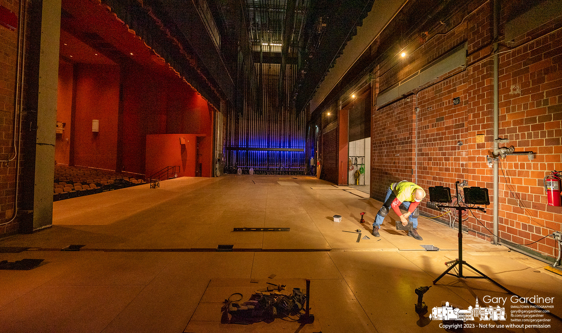 A worker checks alignment on one of the last sections of flooring installed in the stage in Cowan Hall at Otterbein University completing repairs to the water-damaged structure before it gets a final coat of paint. My Final Photo for March 29, 2023.