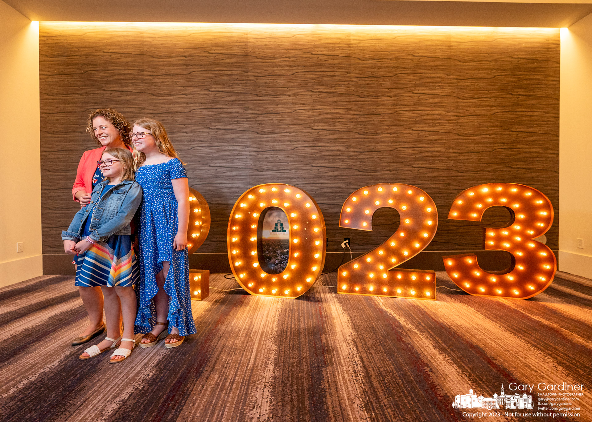 Mother and her children pose in front of a 2023 lighted display before Westerville's annual State of the City presentation. My Final Photo for March 16, 2023.