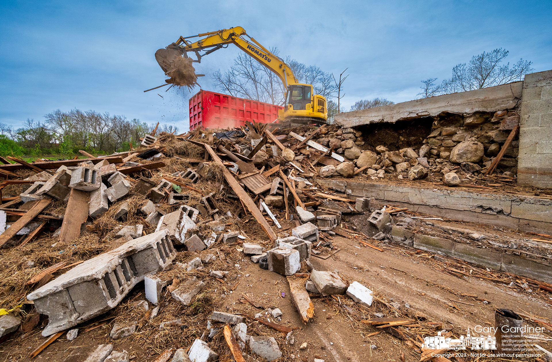A small pile of rubble, the concrete floor, and the rock wall are all that remain of the Braun Farm barn as it and the house are removed to make for future development of the property. My Final Photo for April 17, 2023.