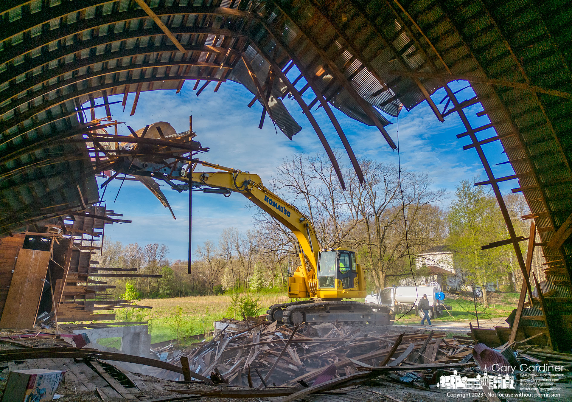 A demolition crew pulls down the Braun Farm barn before moving on the farmhouse, at rear, removing the last two farm buildings from the property on Cleveland Ave. My Final Photo for April 14, 2023.