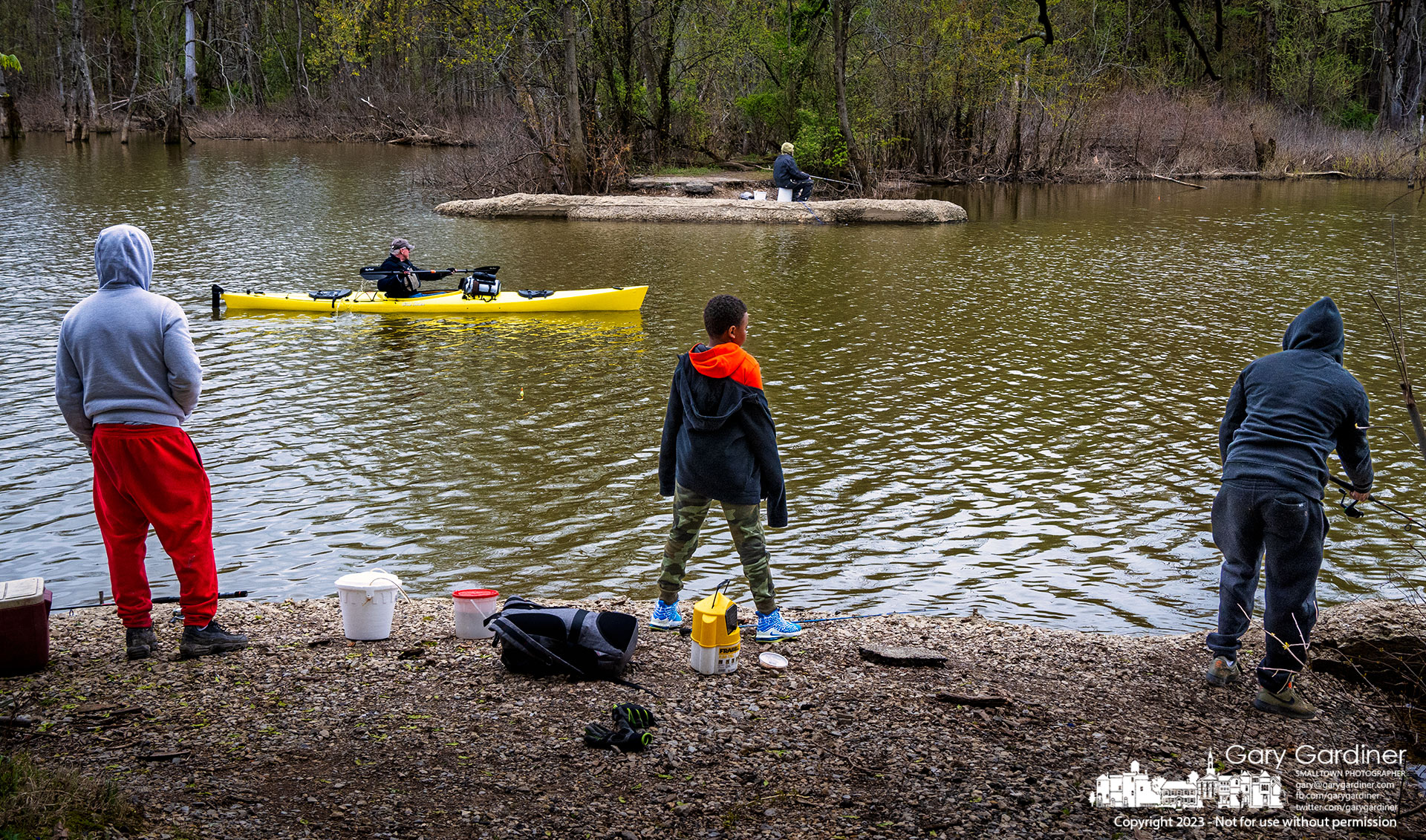 A kayaking angler glides between two sets of fishermen working the shoreline along Big Walnut Creek in Galena. My Final Photo for April 23, 2023.