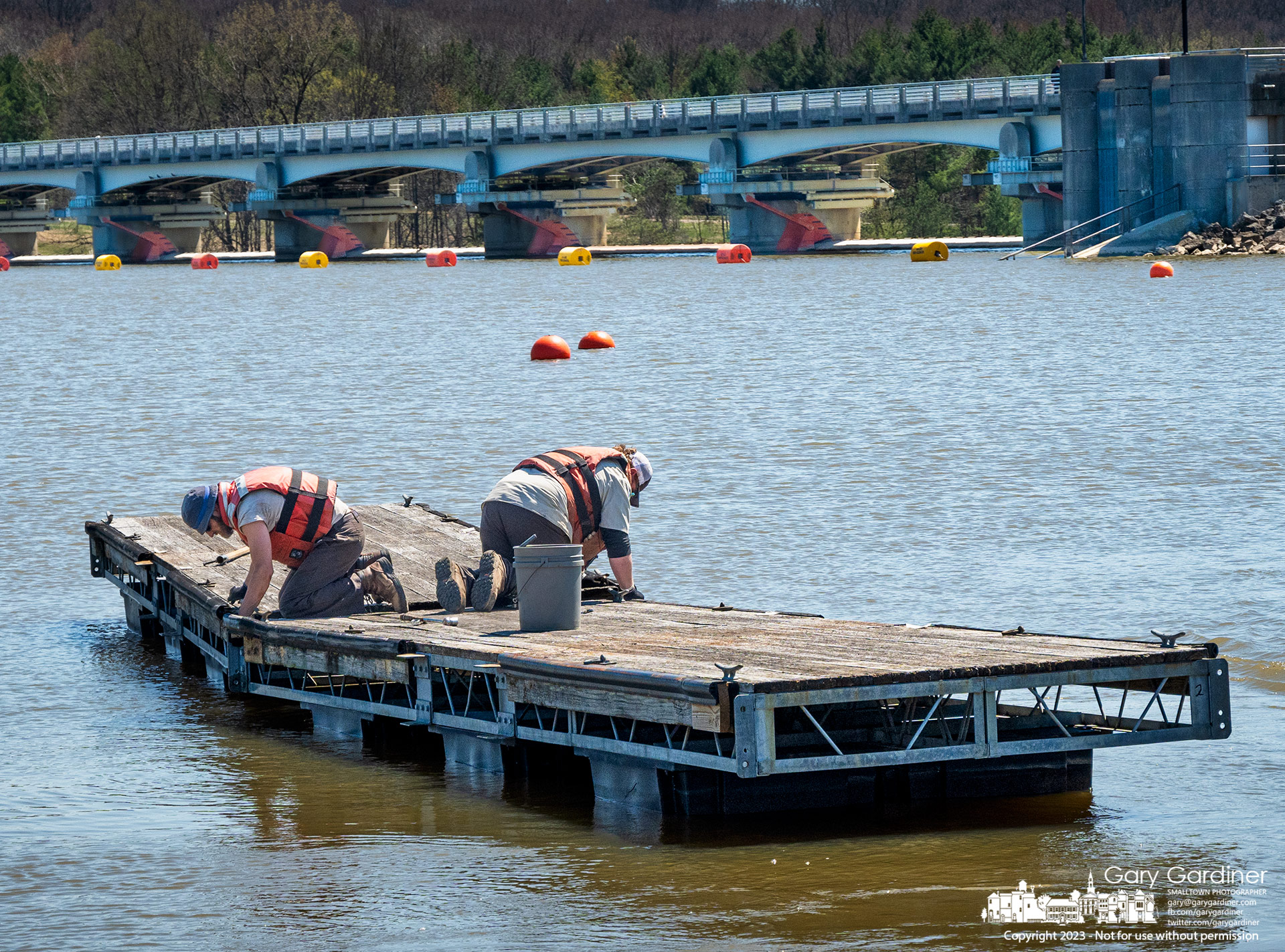 Columbus Parks workers connect two sections of docks before moving them into position to create a small boat harbor just north of the Hoover Reservoir Dam marking one of the signs of Spring. My Final Photo for April 12, 2023.