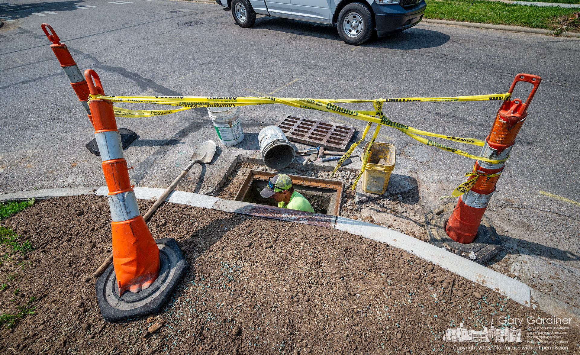 A mason seals a replacement drain on East College as work continues to resurface College from State to Spring. My Final Photo for May 22, 2023.