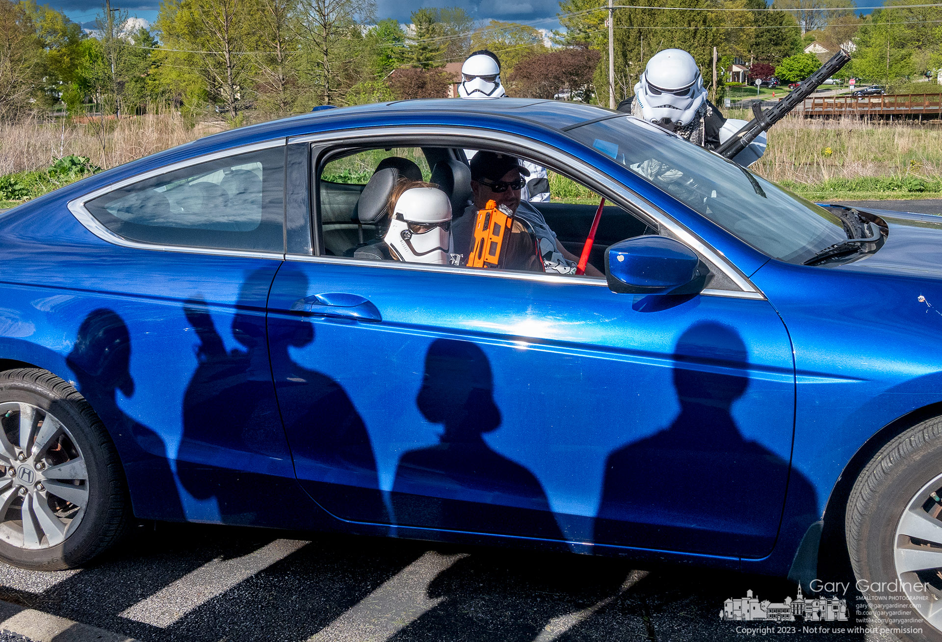 Shadows from a phalanx of Imperial Guard fall on a vehicle being investigated by Stormtroopers at Highlands Pool before dropping off food items for W.A.R.M. on Star Wars Day, May 4. My Final Photo for May 4, 2023.