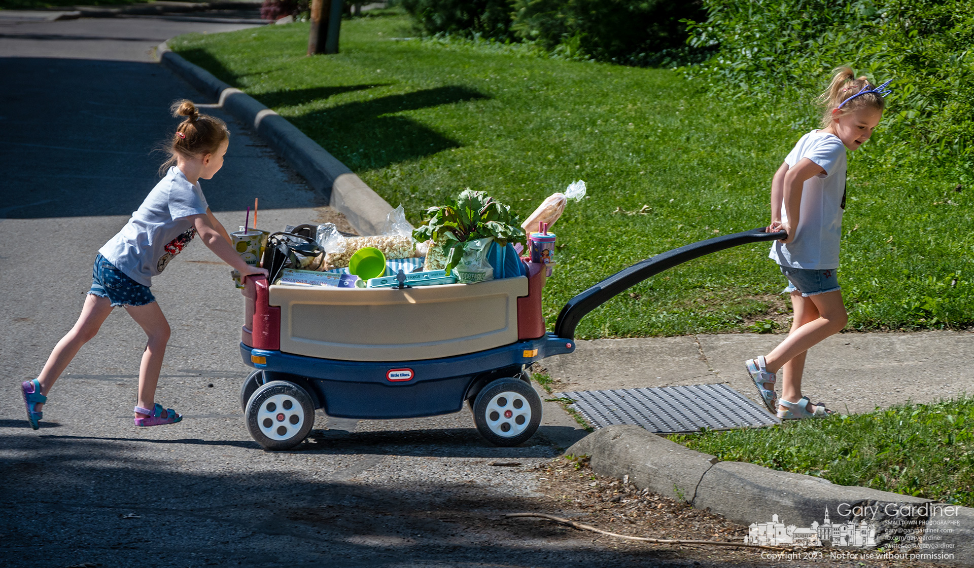 Sisters push and pull their fully-loaded wagon home after spending part of Saturday morning shopping at the Uptown Westerville Farmers Market. My Final Photo for May  7, 2023.