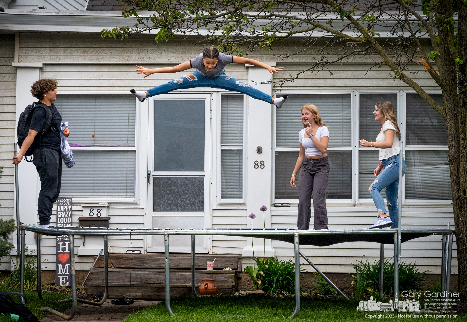 Blendon Middle School students watch their friend jump on the trampoline in her front yard before taking their turn after pausing on their way home after school. My Final Photo for May 8, 2023.