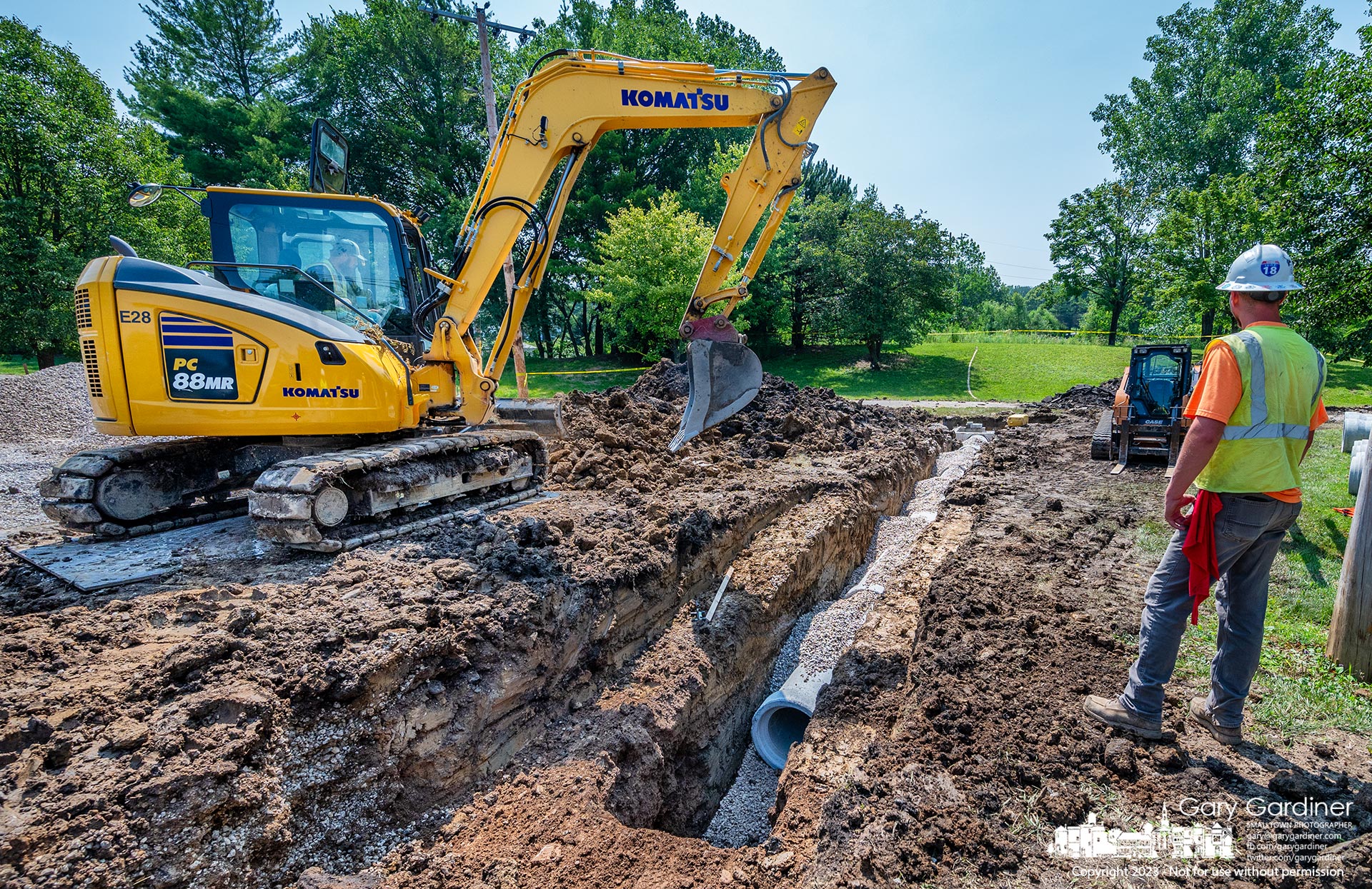 A work crew covers a section of storm drain that when fully connected will move high water from a section of Walnut Street to the wetlands at Highlands Park. My Final Photo for July 26, 2023. 