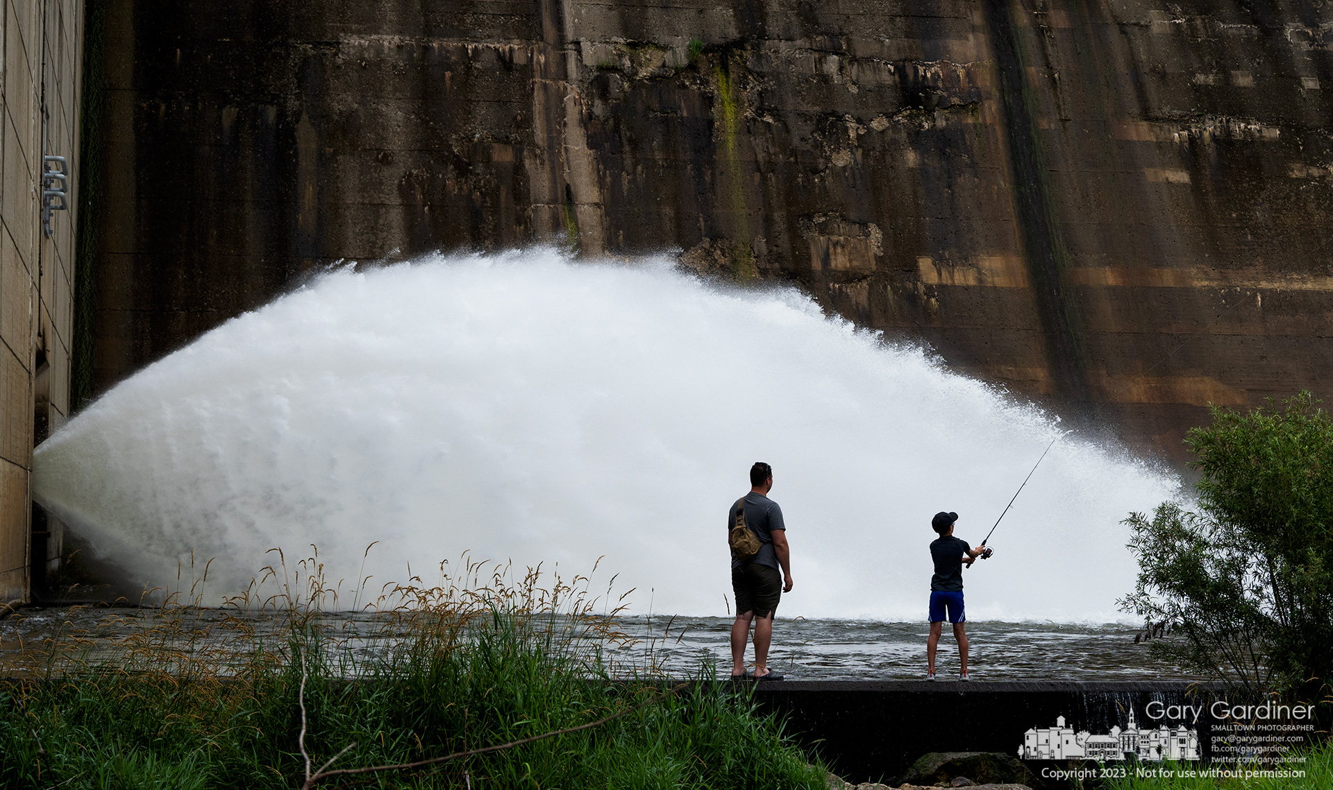 Father and son stand on the retaining wall below the Hoover Reservoir dam spillway hoping they've chosen both the proper lure and the right spot for fishing. My Final Photo for July 3, 2023.