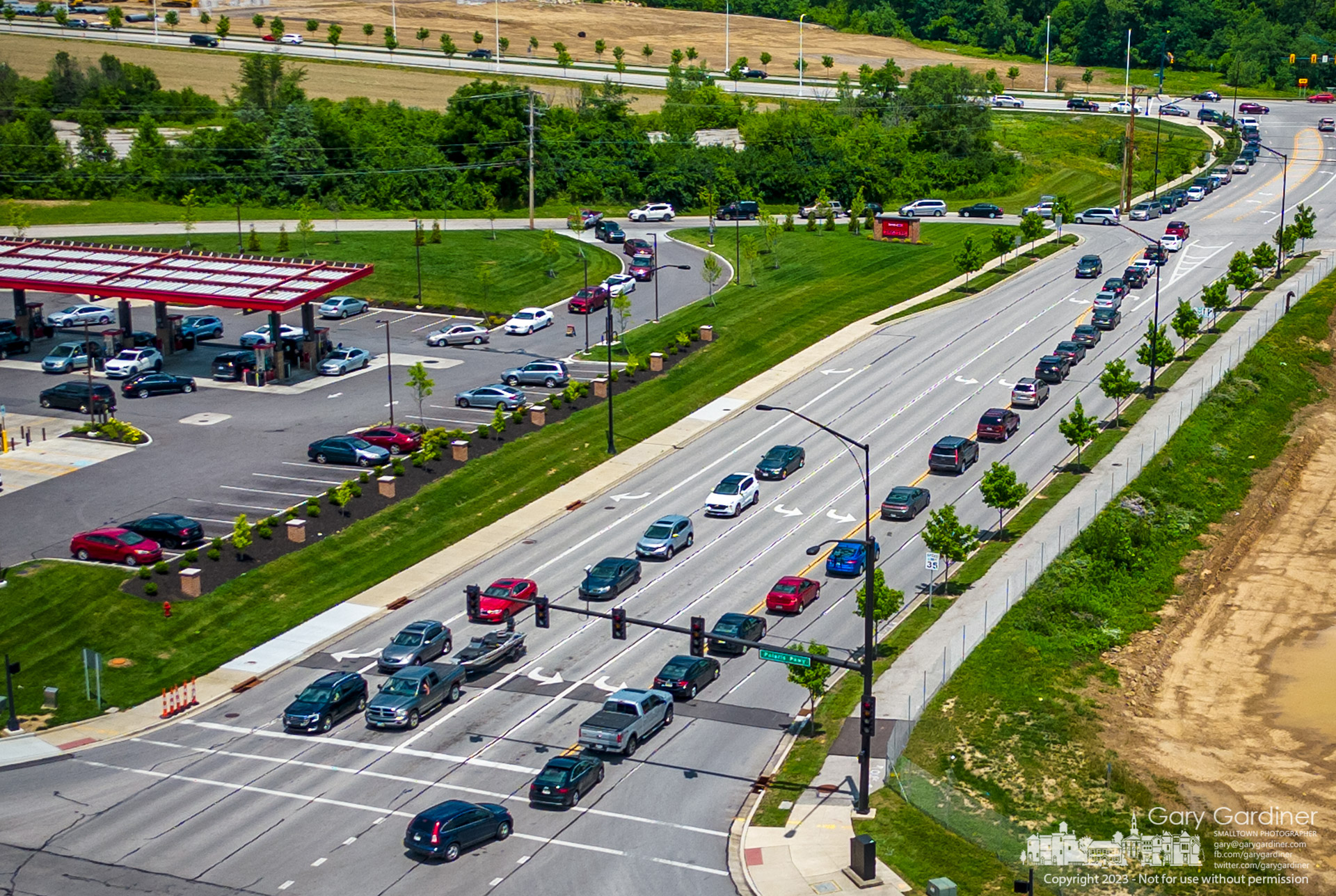 Lines of cars eager to buy $1.776 a gallon gasoline snake onto the roadway from Sheetz on Polaris Parkway and Worthington Road where the company lowered the price on all types of fuel on July 4. My Final Photo for July 4, 2023.