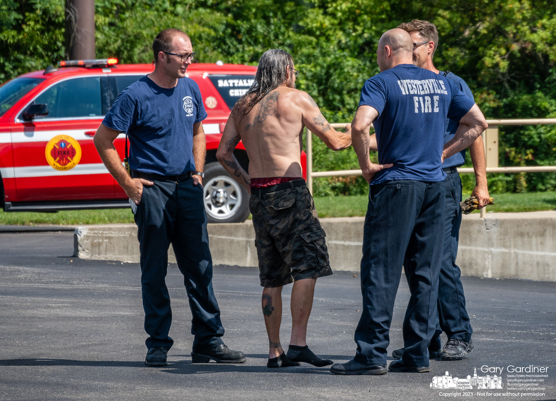 A man who rode his kayak over the lowhead dam at Alum Creek Park North in Westerville offers a thank you and a handshake to some if the Westerville firefighters who came to his aid. My Final Photo for August 26, 2023.