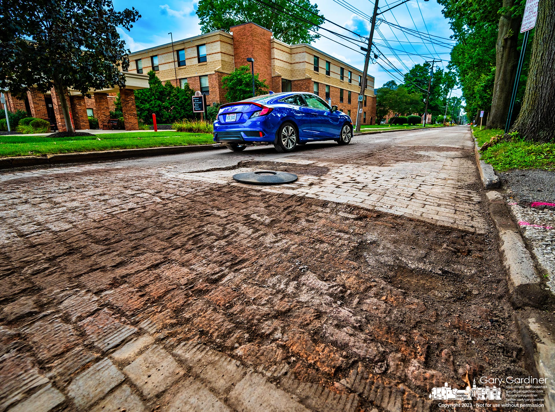 Paving bricks sit exposed on West Home Street after a paving crew milled away the asphalt surface preparing it for repaving this weekend before the arrival next week of first-year students at Otterbein University. My Final Photo for August 11, 2023.