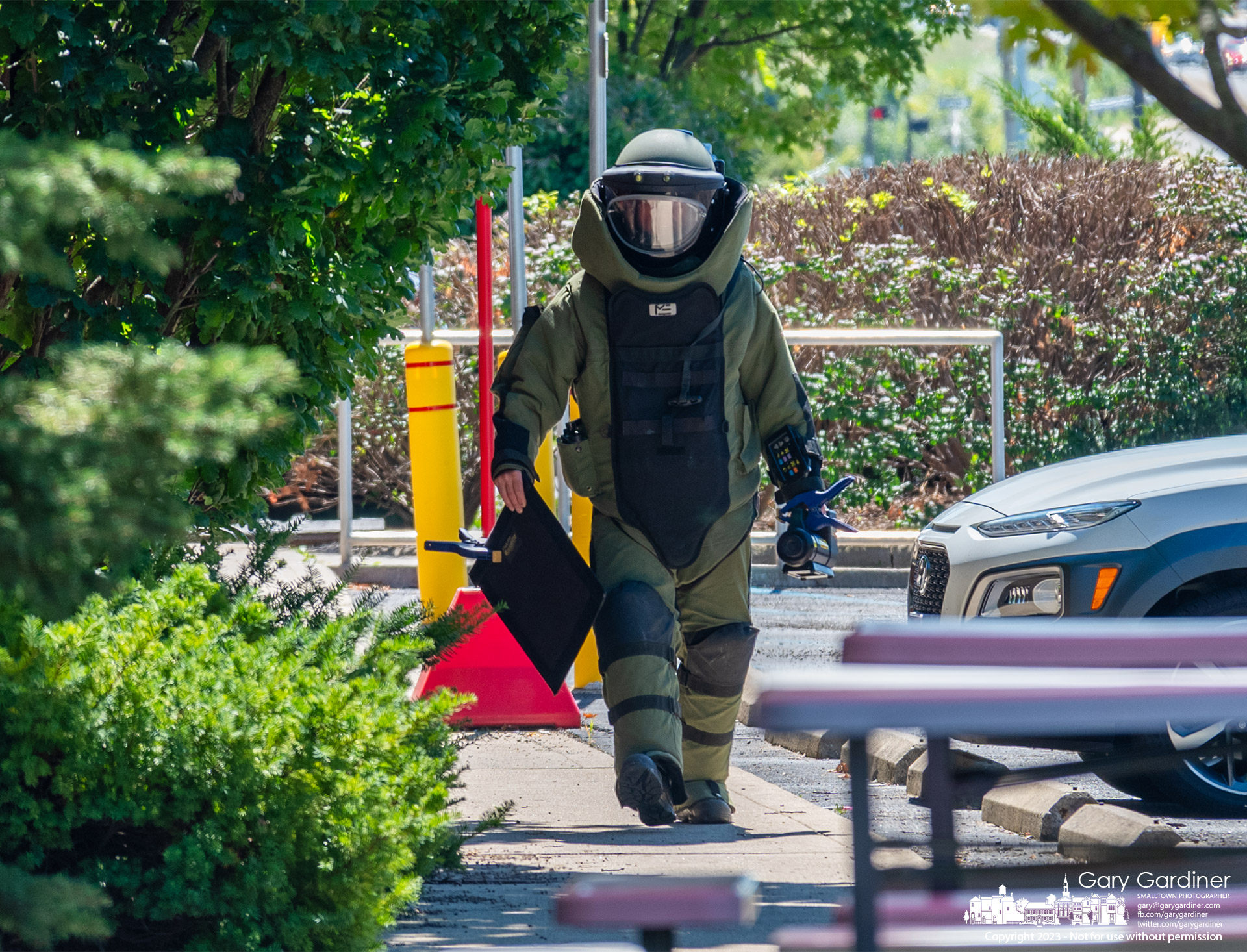 A Columbus police bomb squad officer carries tools he used to test a suspicious package placed on the sidewalk in the parking lot of the CVS pharmacy at Cleveland Ave. and Schrock Road. My Final Photo for September 1, 2023.