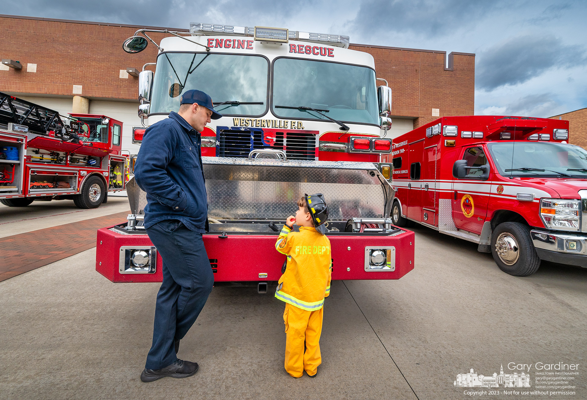 A Westerville firefighter talks with a young boy about the same age as his son during the fire department's open house at the main fire station on West Main St. My Final Photo for October 8, 2023.