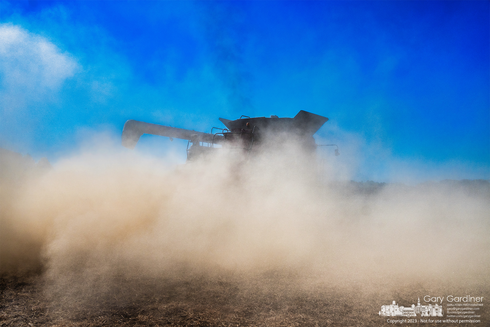 A dust cloud from harvesting soybeans envelops the combine working the lower field on the Yarnell Farm in Westerville. My Final Photo for October 23, 2023.