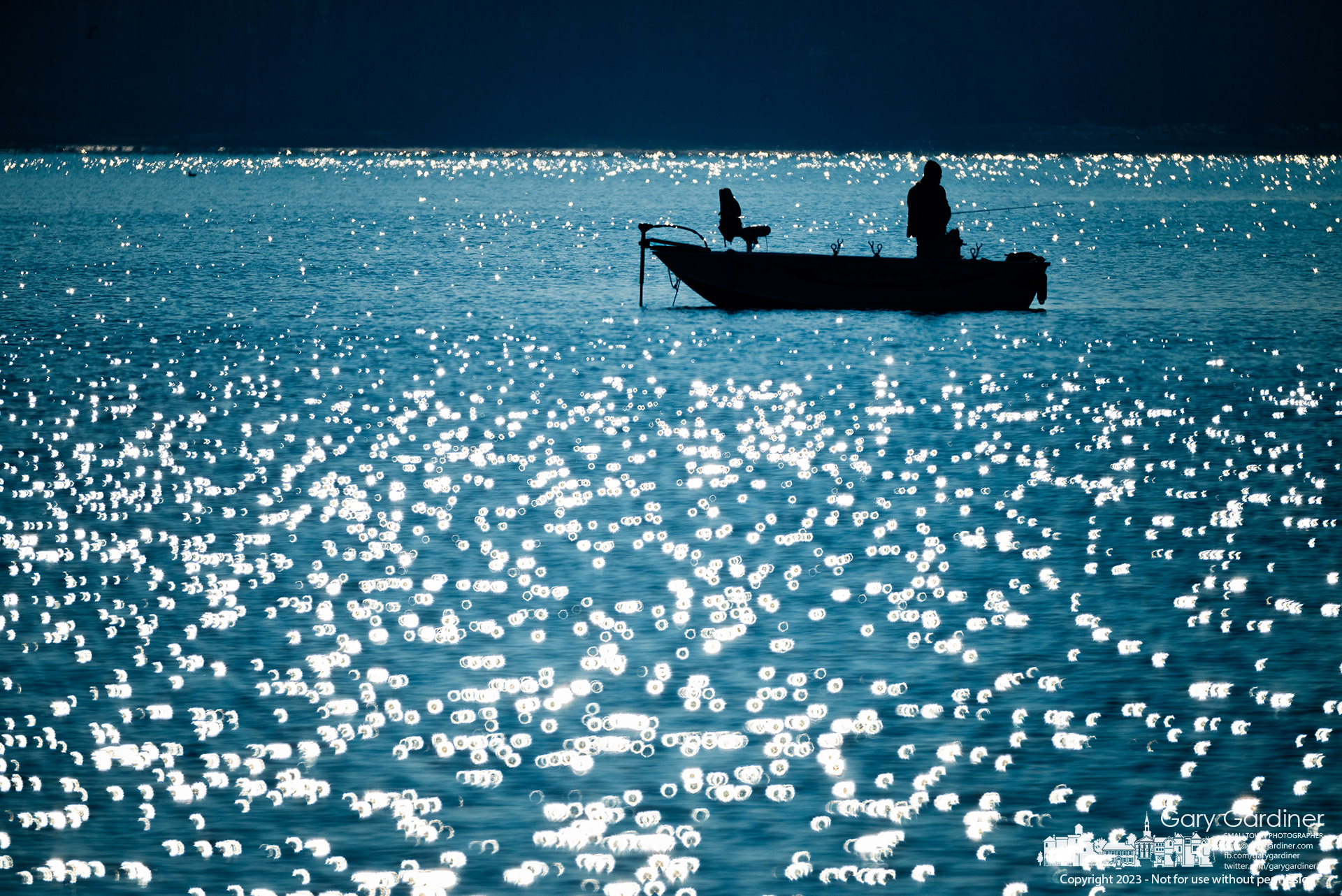 Hoover Reservoir sparkles in the morning sun lighting the path for a fisherman working for good luck in a deeper portion of the lake. My Final Photo for November 5, 2023.