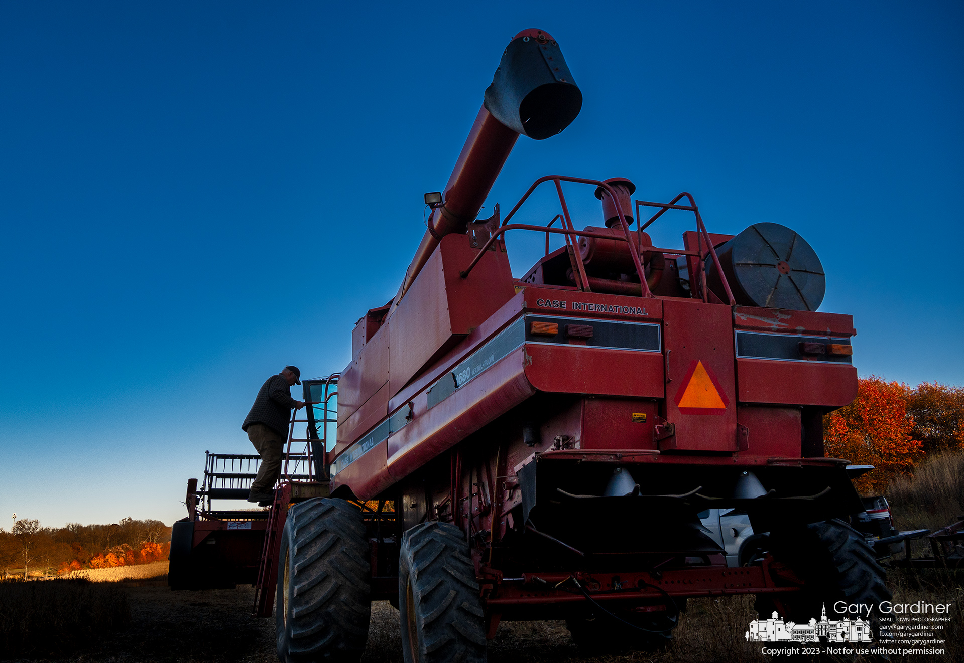 Kevin Scott steps down from his combine harvesting soybeans at the Braun Farm about 10 minutes after sunset. My final Photo for November 13, 2023.