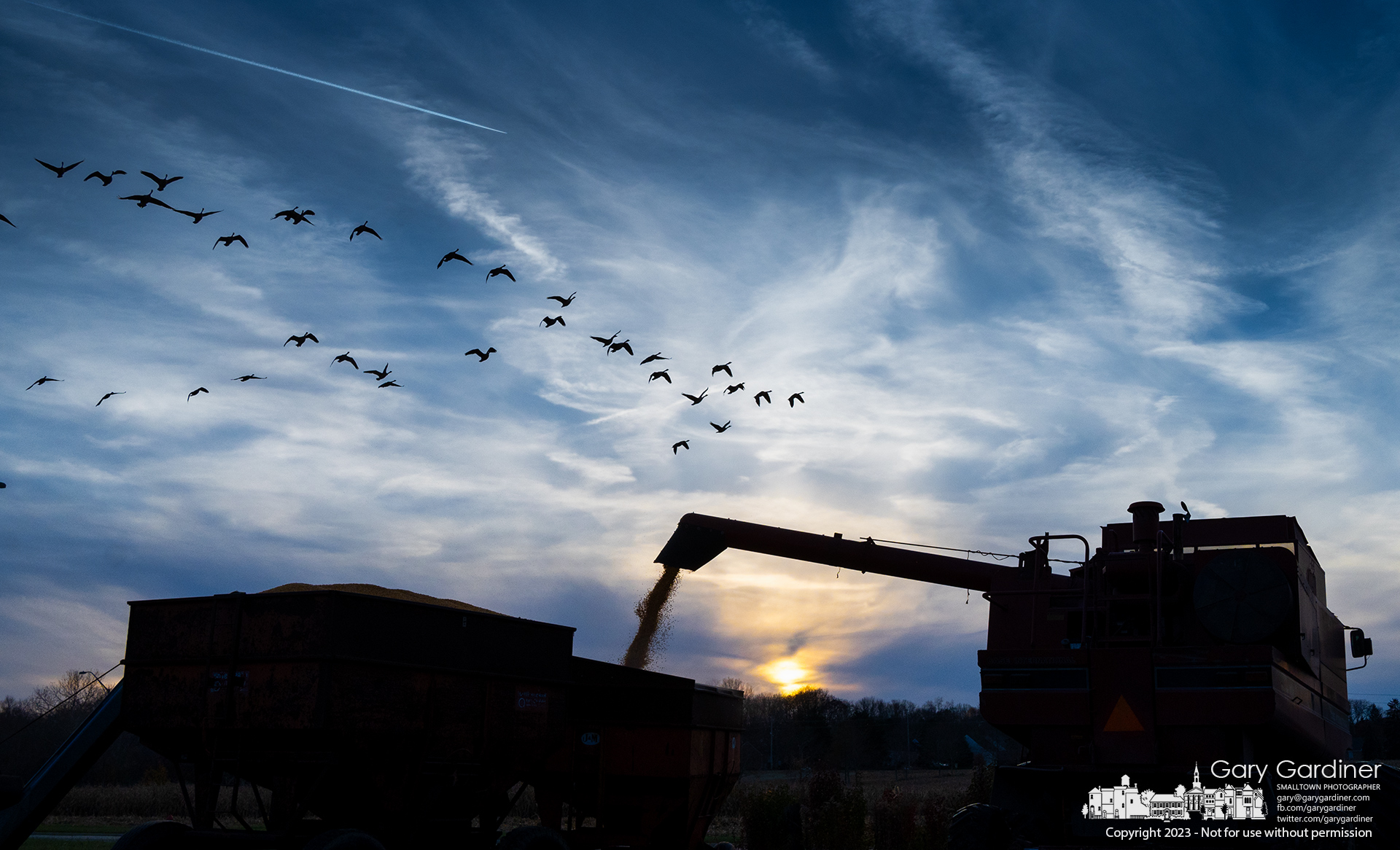 Kevin Scott dumps corn into a wagon as he works towards darkening skies at sunset running the combine at the Braun Farm. My Final Photo for November 24, 2023.