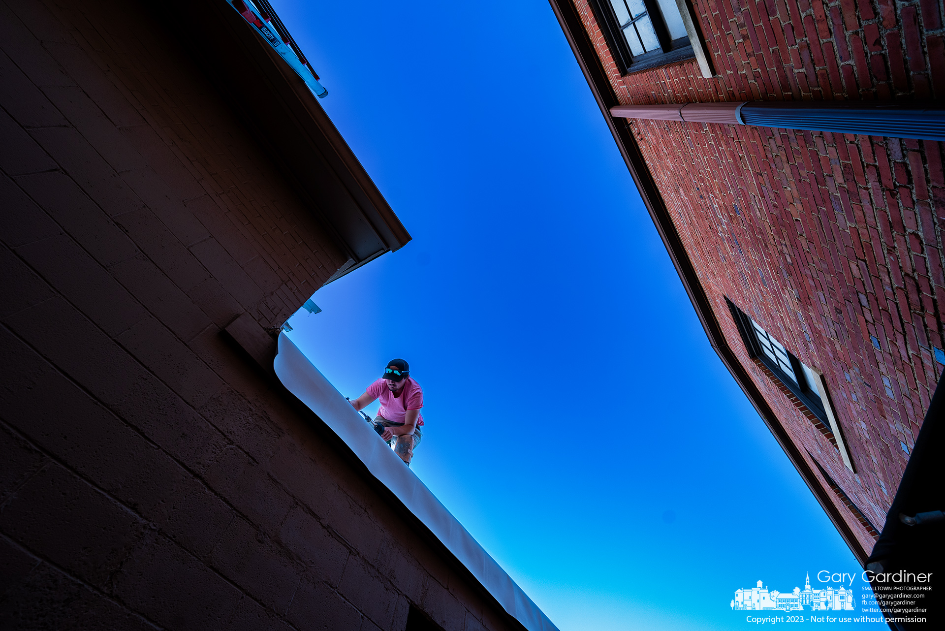 A roofer seals seams along the edge of a new roofing bladder installed at 18 North State Street in Uptown. My Final Photo for November 14, 2023.