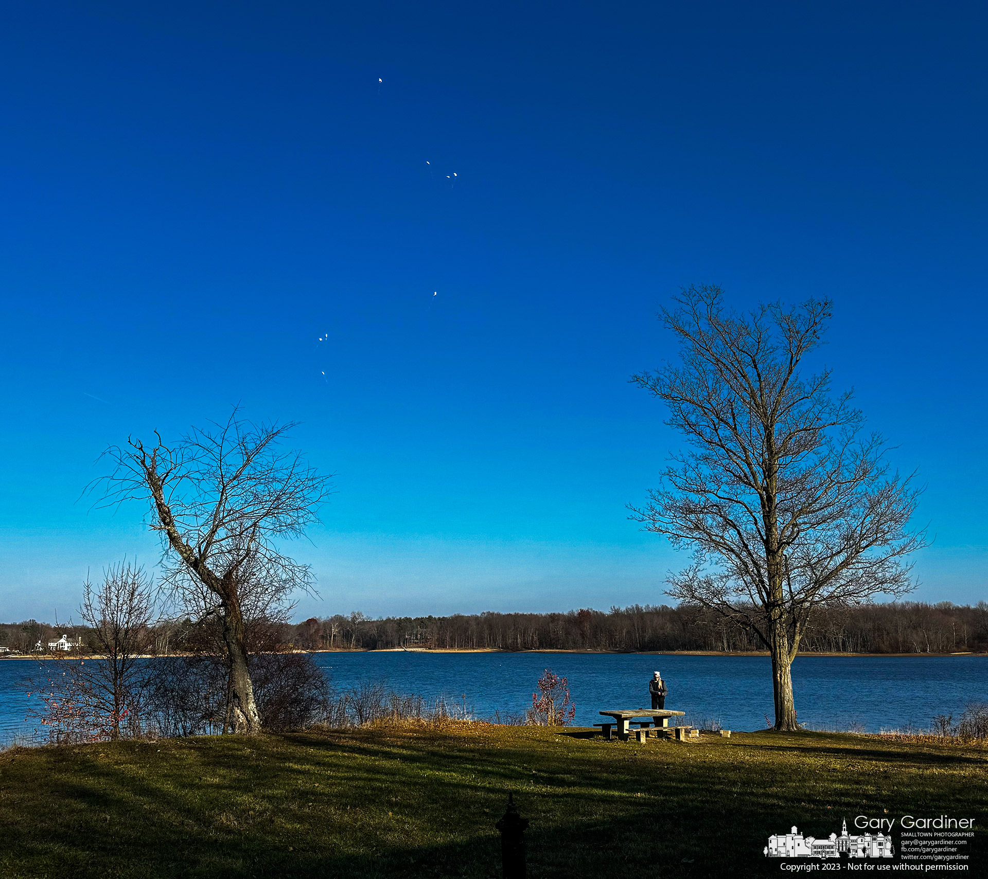 A woman watched eight helium-filled balloons float over Hoover Reservoir after she released the silent memorial from Red Bank Park at the lake on thanksgiving Day. My Final Photo for November 23, 2023.