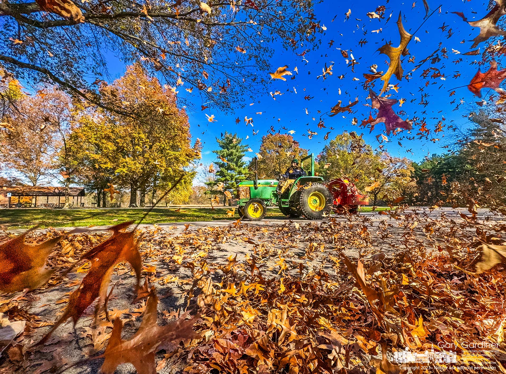 This week begins the once-a-year removal of leaves from the play areas at Sharon Woods Metro Park when the leaves are blown across fields and roads into the nearby woods using a tractor hauling an oversized leaf blower. My Final Photo for November 2, 2023.