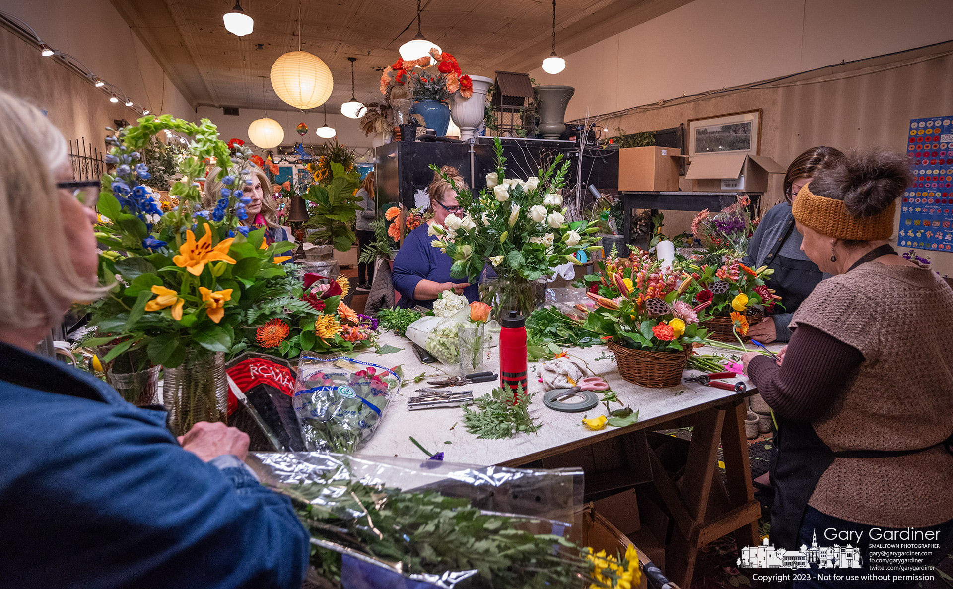 Florists at Talbott's Flowers in Uptown Westerville finish building Thanksgiving table centerpieces and a birthday centerpiece as they work toward the end of the day before the holiday. My Final Photo for November 22, 2023.