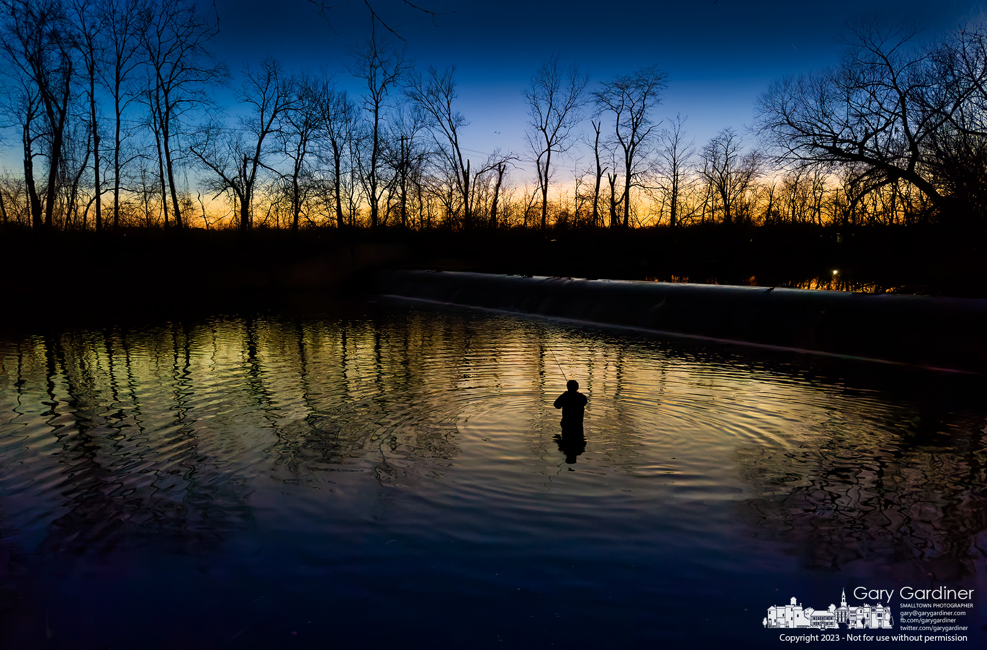 A fisherman wades into the shallow waters beneath the Alum Creek North Park dam, hoping to catch his limit under the fading sunset sky. My Final Photo for December 7, 2023.