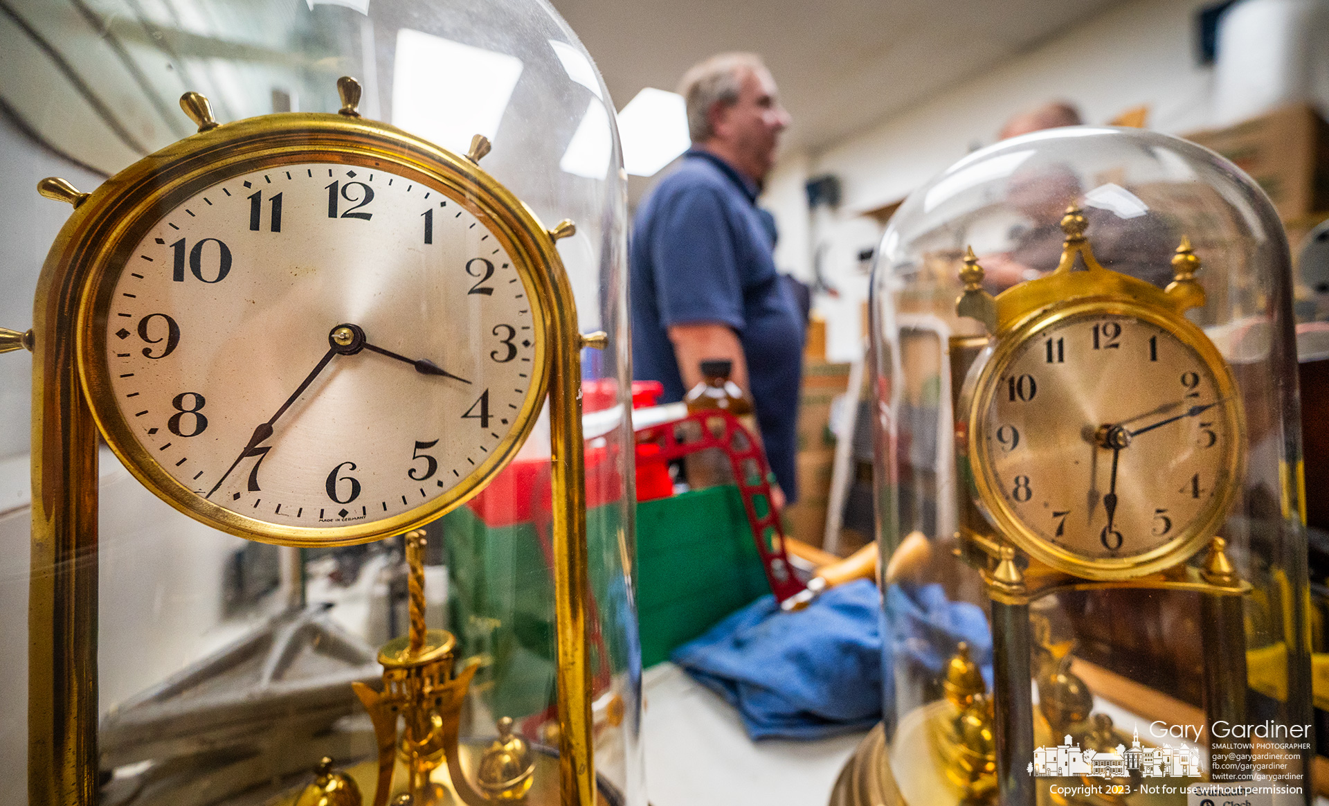 Two of the collection of clocks at Grandfather Clock Company in Uptown Westerville sit on a bench in the workshop as the company prepares to leave Uptown for a storefront on South State Street. My Final Photo for December 26, 2023.